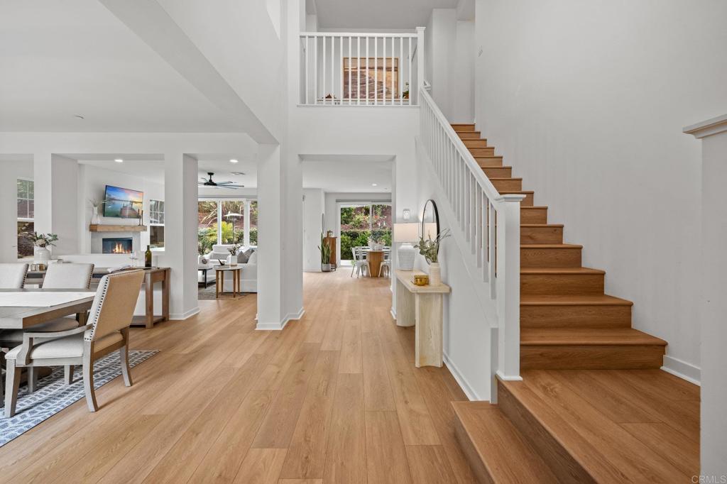 Modern Luxury Meets Coastal Comfort in the Heart of Carlsbad. Welcome to 3115 Afton Way—where thoughtful design, high-end upgrades, and everyday privacy come together in one exceptional turnkey home. Built in 2018 and tucked away on a quiet cul-de-sac, this move-in ready gem offers spacious living, modern energy efficiency, and a prime location just minutes from Carlsbad’s beaches, village shops, and top-rated schools. Step inside to a bright, open floor plan with soaring ceiling, new designer wood tile flooring, interior paint, lighting and airy living spaces designed for both gathering and retreat. At the heart of the home is a dream kitchen featuring double ovens, a walk-in pantry, two dishwashers, a farmhouse sink, and expansive counters—ideal for both entertaining and everyday life.With five generous bedrooms and a versatile loft-style game room, the layout offers flexibility for multigenerational living, guests, or remote work. A main-level suite provides privacy and comfort, while the upstairs primary retreat boasts a spa-like bath, oversized walk-in closet, dual sided fireplace and a cozy sitting area or home office—all with serene northeast views. Step outside to your private backyard oasis, thoughtfully designed for easy entertaining and year-round enjoyment. Highlights include new brick pavers, artificial turf, a built-in fire pit, a relocated BBQ area for improved flow, and a hot tub surrounded by lush eucalyptus and fruit trees. Additional exterior enhancements have transformed the space with upgraded lighting, irrigation, shade canopies, fresh paint, and modern outdoor electrical, and there is plenty of room to add a pool. The home also features a fully paid 7kW solar system installed in 2023—providing enough power to run the entire household, charge an electric vehicle, and keep the hot tub ready for a relaxing soak—all while significantly reducing energy costs. A spacious three-car garage offers ample room for storage, complete with a mudroom and a separate bonus room perfect for a home office or gear room.Located within walking distance to Carlsbad High School, Valley Middle, and Magnolia Elementary, and set in a peaceful neighborhood with no through-traffic and 24-hour community surveillance, this home truly offers the best of both comfort and convenience. Don’t miss the rare opportunity to own a meticulously upgraded, energy-efficient retreat in one of Carlsbad’s most desirable communities—just minutes to the beach, Carlsbad Village, award-winning restaurants, and major freeways. To view Video click/cut&paste https://listing.hiverealestatemedia.com/vd/201732881