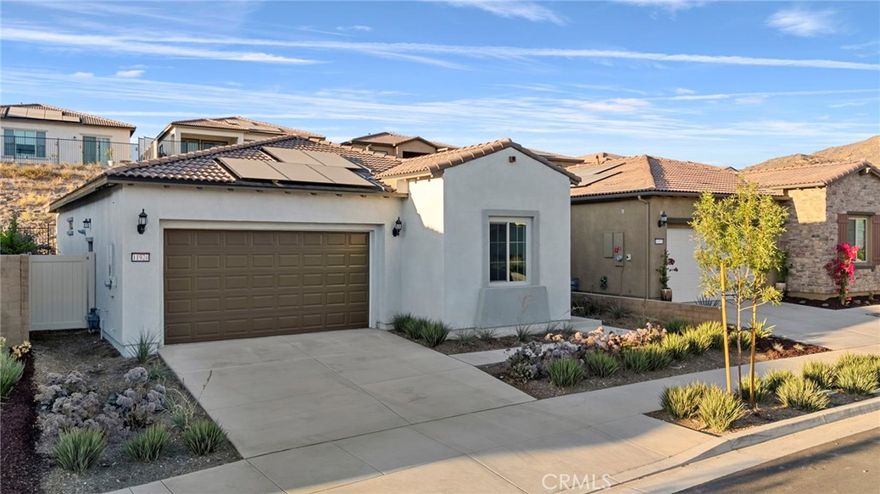 Welcome to 11920 Shadeland, situated above Temescal Valley in the Cedarwood neighborhood of Terramor, a vibrant 55+ Active Adult community. This brand new single-story rental home features 2 bedrooms and 2 bathrooms, and is ready for you to move in! This lovely home offers a spacious great room that seamlessly flows into a gourmet kitchen, complete with an oversized island topped with Calcutta quartz countertops and upgraded walnut shaker-style cabinetry. The kitchen is equipped with stainless steel appliances, including a designer hood, convection microwave, full-size oven, and a 6-burner cooktop. The floors are adorned with luxury vinyl planks in a warm walnut hue, with plush carpeting in the bedrooms for added comfort. The primary ensuite offers an oversized stand-up shower, dual vanity, walk-in closet, and a convenient linen closet. The second spacious bedroom is complemented by a hallway bathroom featuring a relaxing soaking tub. The virtually maintenance-free backyard is beautifully designed with system pavers and includes an enclosed patio, perfect for outdoor enjoyment. Other features include Recessed lighting, an indoor laundry room with hookups, an attached two-car garage, 10-foot ceilings throughout, a house fan, and solar power to keep your electric costs low. Included in your lease is access to the social and recreational Terrace Club, which offers two community clubhouses, a gym, an outdoor pool and spa, an indoor saltwater pool, bocce ball and pickleball courts, and miles of walking trails to keep you active and engaged. You'll also enjoy close proximity to world-famous Tom’s Farms, shopping