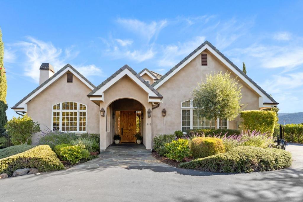 Embrace the sweeping views of the Western Hills from this stunning two-story home, perfectly situated on a 1.28-acre lot. The heart of the home is the gourmet chef's kitchen featuring a large center island, double dishwashers, wine fridge, 6 burner gas stove, bar seating, sub-zero fridge & tons of storage. The kitchen seamlessly opens to a spacious family room w/ window seating, a fireplace, soaring vaulted ceilings & access to the backyard. In addition, the main floor boasts 2 ensuite bedrooms, a formal dining room, a beautiful bright living room, cozy den with gorgeous built-ins, & a dedicated full bathroom w/ access to the yard. The rich hardwood floors, wonderful natural light, lots of windows & fabulous indoor/outdoor flow allows this home to cater to many lifestyles. Upstairs, the primary bedroom suite is a true retreat offering a fireplace, sitting area, spa like bathroom and walk-in closet. An additional ensuite bedroom & open office/play area complete the upper level. The expansive & private backyard is ideal for everyday relaxation and entertaining with a large flat area, garden beds, a sparkling pool & a patio featuring an outdoor kitchen. Located within in the excellent Woodside School district, this home offers both luxury and comfort in a serene convenient location.