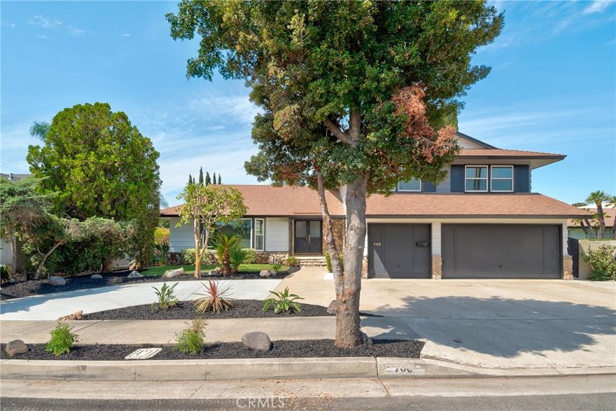 Welcome to 700 S Yorba, a spacious and inviting 4-bedroom + office, 3-bath home offering 2,638 sq ft of modern, light-filled living. Updated kitchen includes granite countertops and a kitchen nook that opens up to the family room.  Off the kitchen you'll find the perfect spot for a home office (or optional 5th bedroom/no closet).  The spacious family room is highlighted by a large, natural stone, gas wood burning fireplace and double sliding doors that open up to the low maintenance backyard.  The kitchen, nook and family room all offer views of the pool and backyard! Outside you find a solid covered patio (perfect dining al fresco with family and friends) and a sparkling pool.  Upstairs you'll find four additional four additional bedrooms including a primary bedroom with an ensuite bathroom and separate vanity area.  Did we mention solar? This home has a 10KW solar system (fully paid off!).  Like to entertain or have lots of cars? This home has both a 3 car driveway plus a horseshoe shaped driveway plus street parking!  Must see this thoughtfully designed, split level home that will host both your everyday living as well as gatherings.  New carpet, new paint, indoor laundry room, direct access garage, new sod...this home has it all.