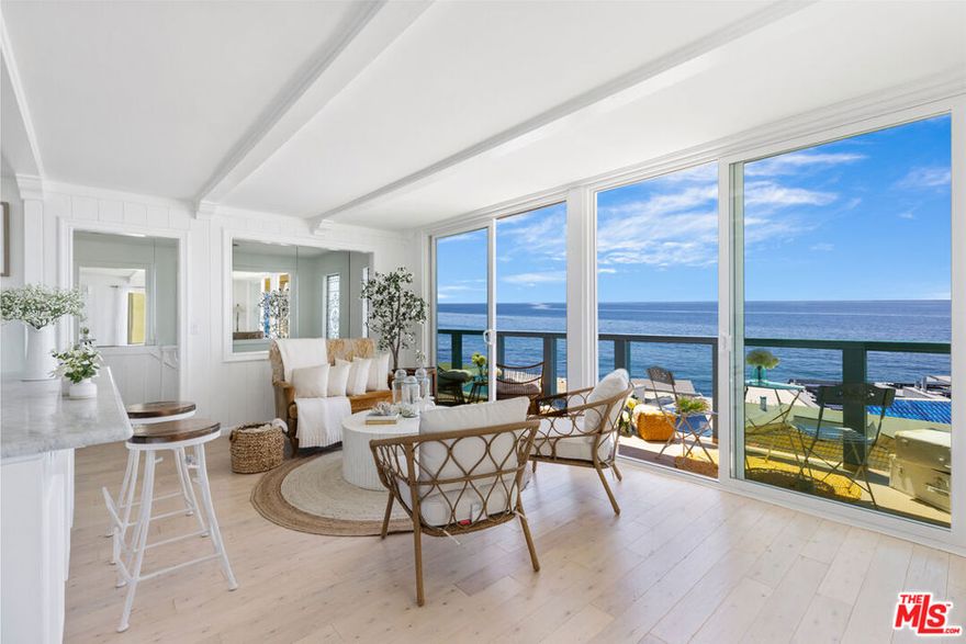 The most fantastic beach retreat! It's a corner unit with double ocean views. This one-bedroom charmer is a high-end remodeled condo featuring the highest quality finishes, fixtures and appliances. The gourmet kitchen features a Smeg refrigerator, a Big Chill oven and Big Chill induction cook top. The Carrera marble countertops, custom cabinets and Waterworks faucet complete the chic look. The floors are a beautiful hardwood, and they run throughout the living room, bedroom, and office space. The two bathrooms feature Restoration Hardware  faucets on showers and sinks. They also include fan-heater units by Panasonic. In addition they are both equipped with wonderful designer floor tiles. The sliding glass doors leading to the two decks are also new, both upstairs and downstairs. There is also a newer washing machine. Luxuriate on the deck to the sounds and sight of the magnificent ocean. The beach is just a stone's throw away--enjoy it in style in your own vacation paradise. The sounds of the waves and the smell of the ocean are both included! Now is the time to come to Malibu!