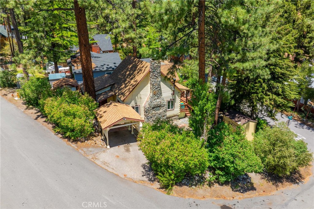 Pride of ownership historical Wrightwood home! Built in 1936, this home has stood the test of time and offers many details that newer homes cannot.
Walking up to the front door, you will feel a sense of calm and serenity in the treehouse like vibes.
The oversize oak front door welcomes you inside, into the large open area on the first floor. Original hardwood oak floors, woodwork, vaulted ceiling and fireplace are some of the features that offer vintage charm.
The kitchen has an efficient work flow and modern day appliances fit into the spaces.
Dining area is open to the living room with cozy fireplace AND house warming wood stove.
One of the bedrooms has direct access with it's own side door, as seen in the photos.
The lot features a good amount of parking and usage. If you were to be in need of RV parking, you could do that here with minimal work. There are three yard areas, and parking is easy.
There is a shed for storage, and a carport.
Located a short distance from the Country Club, post office, the Village trail etc.
This home would be ideal for year round living or have it as a income generating rental.