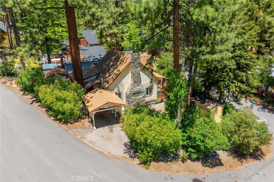 Pride of ownership historical Wrightwood home! Built in 1936, this home has stood the test of time and offers many details that newer homes cannot. 

Walking up to the front door, you will feel a sense of calm and serenity in the treehouse like vibes. 

The oversize oak front door welcomes you inside, into the large open area on the first floor. Original hardwood oak floors, woodwork, vaulted ceiling and fireplace are some of the features that offer vintage charm. 

The kitchen has an efficient work flow and modern day appliances fit into the spaces. 

Dining area is open to the living room with cozy fireplace AND house warming wood stove. 

One of the bedrooms has direct access with it's own side door, as seen in the photos. 

The lot features a good amount of parking and usage. If you were to be in need of RV parking, you could do that here with minimal work. There are three yard areas, and parking is easy. 

There is a shed for storage, and a carport. 

Located a short distance from the Country Club, post office, the Village trail etc. 

This home would be ideal for year round living or have it as a income generating rental.