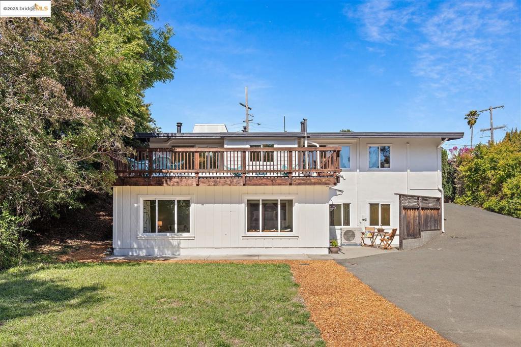 May Valley Mid-Century with Spacious In-law tucked away on a quiet street with more than ample off-street parking, this expansive, updated two-story mid-century home has it all. After parking in your two-car driveway and stepping through the front door, you are greeted with newly refinished hardwood floors, a vaulted ceiling, an open concept living room and dining area with its own mini split heater/air conditioner, and two operable skylights that open for a fresh air infusion, and flood the room with warm natural light. To your left are three well-appointed bedrooms and a spacious bathroom. The primary bedroom has its own mini split heater/air conditioner as well. Straight ahead is a galley kitchen with a new refrigerator (2025), large windows for lots of natural light, and a door to a large backyard deck with wooded hill views – perfect for outdoor entertaining or intimate al fresco dining for two. The lower level has been legally converted into a large in-law suite. Enjoy the living area with a full kitchen, open floor plan, and dining area with French doors that open out to the backyard. 2 bedrooms and an additional bonus room, plus two crawl space storage areas. Artistic custom slate tile floors and Milgard double-pane windows throughout. Views: Ridge