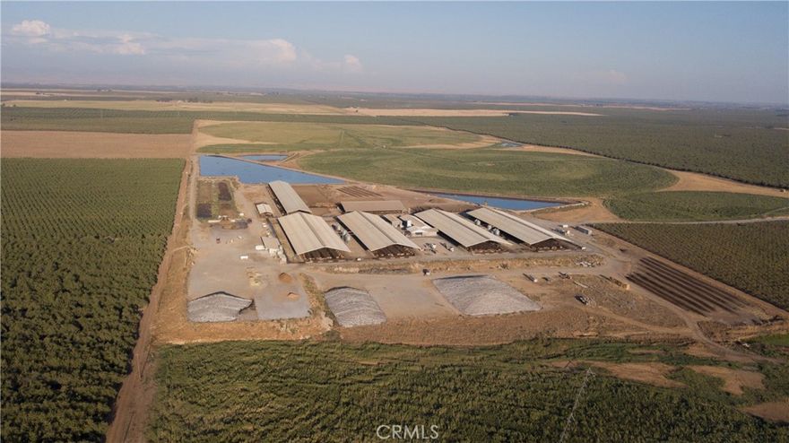 This facility, totaling approximately 820 acres, presents an unparalleled opportunity for those seeking a state-of-the-art dairy operation combined with highly productive agricultural land. This property seamlessly integrates modern dairy technology with productive farmland, catering to both immediate operational needs and long-term agricultural investment. Equipped with four expansive free stall barns, utilizing Thirty two Lely A5 robotic milking systems. In addition, there are two compost barns: one for dry cows and another for closeup and hospital use. A special needs free stall barn offering 60 stalls, three Albers manure separators, and a substantial commodity barn. There are two 7000 gallon BouMatic milk tanks with refrigeration and a 7000 gallon Westfalia milk holding tank. The hospital barn is equipped with a double 8 herringbone parlor, ensuring the highest standards of animal health management. Feed systems are supported by eight 20-ton grain tanks and eight Lely Juno feed pushers. There are three water tanks each holding 50,000 gallons for fire and class 2 water systems. Submersible pumps and irrigation wells provide consistent water powered by TID and PG&E. Residences: Custom built 4 bed/4.5 bath home (Life Estate), separate 3 bed/2.5 bath modular home and shop