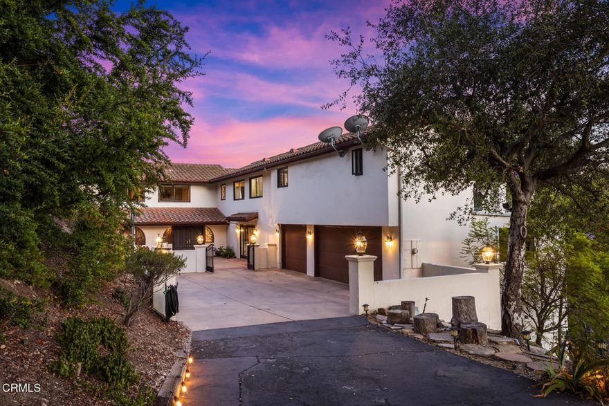 Set behind private gates on over an acre of land, this updated and secluded residence offers an exceptional blend of privacy, tranquility, and sweeping views of the city skyline and surrounding mountains. Thoughtfully designed to accommodate both large-scale entertaining and comfortable everyday living, the home welcomes you with a spacious front patio and a gracious formal entry. Inside, the expansive living room features soaring ceilings, a dramatic stone fireplace, and direct access to a view deck, an ideal space for seamless indoor-outdoor entertaining. A separate family room, outfitted with custom built-in bookshelves and a wet bar, also opens to the deck and provides a warm, inviting space with breathtaking vistas. The remodeled kitchen is equipped with a generous center island with seating, top-of-the-line stainless steel appliances, and connects effortlessly to the adjacent dining room, perfect for both formal occasions and casual meals. The main level offers two bedrooms, including one that is ideal for use as a home office. Upstairs, accessible both by stairs and an elevator, are six additional bedrooms, including two luxurious primary suites. The main primary retreat features its own private patio with captivating views of Downtown Los Angeles, while the second primary suite enjoys a private balcony. A well-appointed laundry room completes the upper level for added convenience.Located at the border of La Canada Flintridge and Glendale, this extraordinary home offers easy access to the best of both communities. Additional highlights include an 830 SF three-car garage and a sauna, enhancing the home's balance of function and comfort. Blending timeless design, refined updates, and unmatched views, this exceptional estate presents a rare opportunity to enjoy space and serenity.