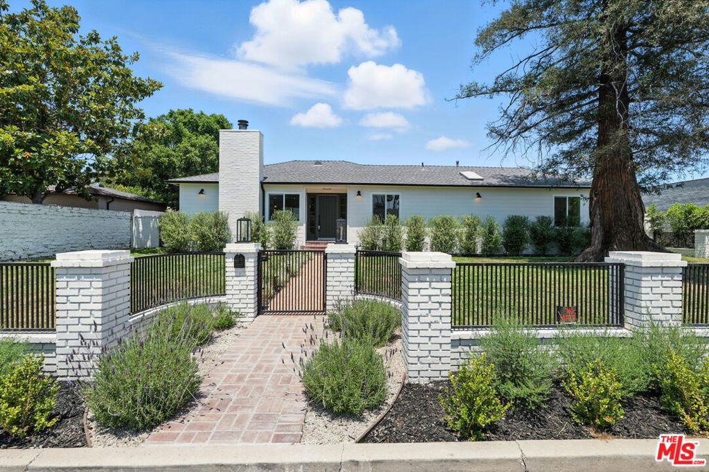 Discover a private retreat in the heart of Encino, nestled on a quiet cul-de-sac within the coveted Hesby Oaks School District. This fully gated property offers 2,000 sq.ft of luxurious, versatile living space on a nearly 10,000 sq ft lot. The main residence features 3 bedrooms and 2.5 bathrooms with a sun-drenched open floor plan, designer finishes, and a chef's kitchen equipped with Thermador appliances and exquisite Taj Mahal quartzite countertops. A detached, 750 sq ft permitted ADU with 2 bedrooms, 1 bath, and alley access provides the perfect setup for guests, extended family, or rental income. The primary suite opens directly to the lush backyard, creating a serene connection to the resort-style grounds, complete with a sparkling pool and beautifully landscaped surroundings. Enjoy the ultimate in privacy and elegance, just minutes from top-rated schools, fine dining, and upscale shopping. A rare opportunity to experience refined Valley living at its best.