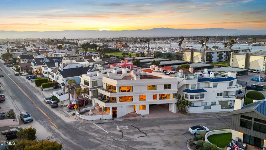 Live the Dream on Hollywood Beach with  Views & Elevator and boat docks available right across the street! 360 degree views of Ocean, Islands, Harbor, Mountains & Built by Walt Phillips!Welcome to your private slice of paradise on Hollywood Beach, where ocean breezes, golden sunsets, & breathtaking island views set the tone for laid-back luxury. Delivered fully furnished, this rare coastal retreat offers ultimate versatility--ideal as your forever home, vacation getaway, or an income-producing beachside investment.Perfectly positioned between Malibu & Santa Barbara, and steps from the Channel Islands Harbor, this oversized corner-lot residence captures panoramic views of the Pacific, Channel Islands, harbor, & surrounding mountains. Spanning approx. 3,900 sq ft, this 3-bed, 3.5-bath home also includes a bonus room (easily a 4th bedroom) & a private elevator for seamless access across three levels of thoughtfully designed space.On the first floor, guests are greeted with a spacious bedroom & bath, plus a family room that opens through glass sliders to a slate patio--ideal for entertaining or relaxing after beachside adventures. Additional conveniences include an outdoor shower & parking for up to four vehicles.The 2nd floor is the heart of the home--an open-concept entertainer's dream. Floor-to-ceiling windows, travertine floors, & a chef's kitchen with Viking appliances, Sub-Zero fridge, granite counters, & center island set the stage for unforgettable moments. A cozy gas fireplace anchors the living area, flowing onto a large deck perfect for sunset cocktails. A guest bath & laundry room complete the floor.On the 3rd floor, the ocean-view primary suite stuns with a fireplace, sitting area, walk-in closet, wet bar, & spa-style bath with jetted tub & steam shower. Another en-suite bedroom rounds out the top floor.The crown jewel? A rooftop deck offering 360 views & a reinforced area ready for a jacuzzi. Soak in the serenity as dolphins play offshore & sunsets paint the sky.Beyond the home, Hollywood Beach offers unmatched lifestyle appeal--surfing, kayaking, yacht clubs, boutique shopping, & dining are all moments away. Whether you're seeking glamour, tranquility, or adventure, this is coastal California at its finest. Come for a day stay for a lifetime!