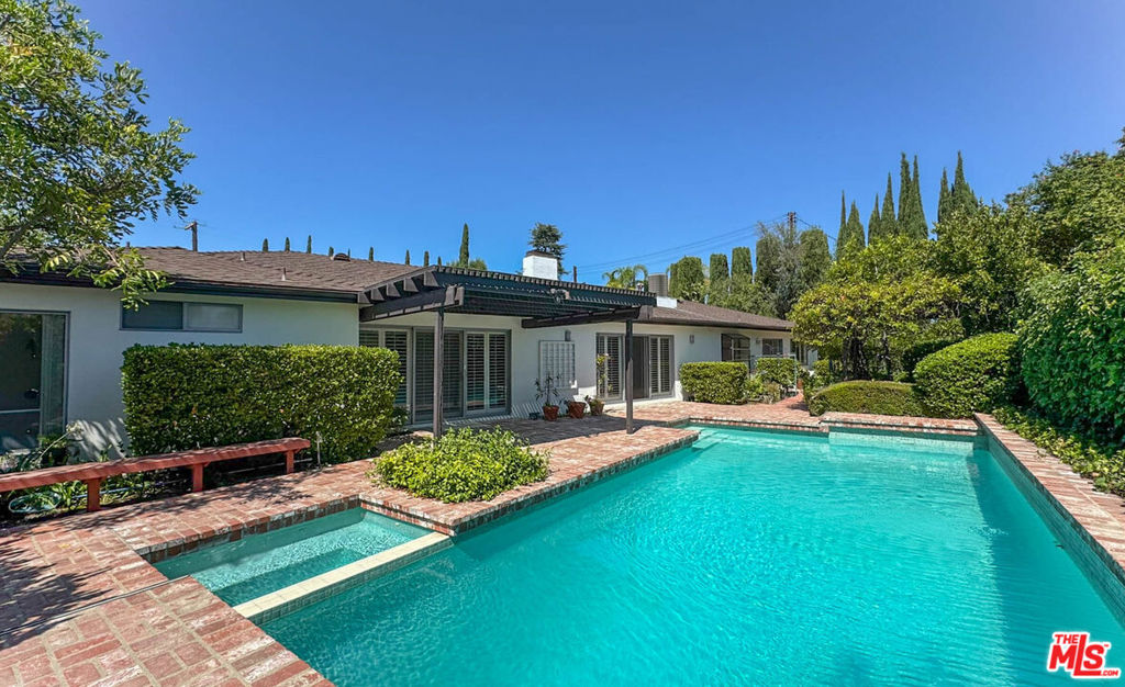 Located in one of Encino's most sought-after neighborhoods, this beautifully appointed 5-bedroom, 3-bathroom home blends luxury, comfort, and quintessential California living. Sunlit living and dining areas sit at the heart of the home, with sliding glass doors that open to a lush backyard, creating effortless indoor-outdoor flow. The thoughtfully designed layout features five spacious bedrooms positioned for both privacy and flexibility, ideal for families, guests, or a home office setup. The expansive primary suite offers a true retreat, complete with a walk-in closet and a spa-like en suite bathroom designed for relaxation. A dedicated laundry area with side-by-side washer and dryer adds everyday convenience, while central A/C keeps the entire home cool and comfortable year-round. The attached garage provides ample space for parking and storage. Step outside to your own private oasis featuring a sparkling pool and soothing Jacuzzi, perfect for unwinding or entertaining. The generous backyard offers plenty of room for barbecues, gardening, or soaking up the Southern California sunshine. A separate dog run ensures your furry friends have their own space to enjoy. Tenant pays all utilities except gardening and pool service.