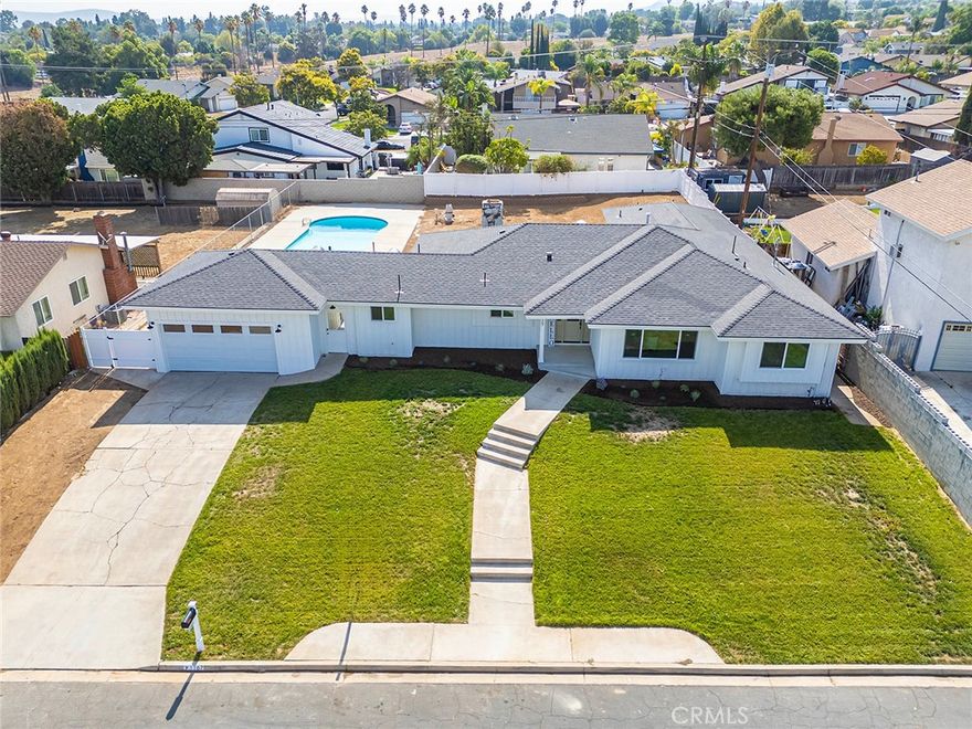 This stunning luxury remodel is far from your typical cookie-cutter track home. With nearly $250K in upgrades, no detail has been overlooked in transforming this 2,683 sqft, single-story residence into a breathtaking private retreat, including a brand new roof, windows, and HVAC system. Step inside and marvel at the spacious layout, complete with all new recessed lighting, luxury vinyl flooring, and designer finishes. The lime-washed stone fireplace serves as the centerpiece of the step-down family room, accentuated by the vaulted wood beam ceiling. It flows into the incredible modern kitchen, featuring quartz countertops and backsplash, pristine white shaker cabinets, stainless steel appliances, a farmhouse sink, center island, cozy dining nook, and plenty of space for all your culinary adventures. You will love the convenient mud room (fully equipped with laundry hookups, a half bathroom, and storage units) that leads out to the breezeway with access to both the 2-car garage and the backyard oasis. The formal dining room is flooded with natural light from the oversized window, and creates the perfect environment to host lavish parties, or even convert into another living area or recreational room. In the right wing of the home, you will find four bedrooms, each unique and beautiful in their own right, plus two full bathrooms. The primary suite offers a walk-in closet, dual vanities, stand-in shower, and a sliding door to the backyard. Sitting on 0.36 acres, your staycation plans have never looked better - take a dip in the newly re-plastered pool, fire up the BBQ on the covered patio, or bring your landscaping dreams to life on this blank canvas! Situated in a peaceful neighborhood just off the 91 freeway, enjoy the prime location close to schools, parks, restaurants, shopping centers, and hiking trails. Your dream home awaits, so schedule your private tour to experience it for yourself today.