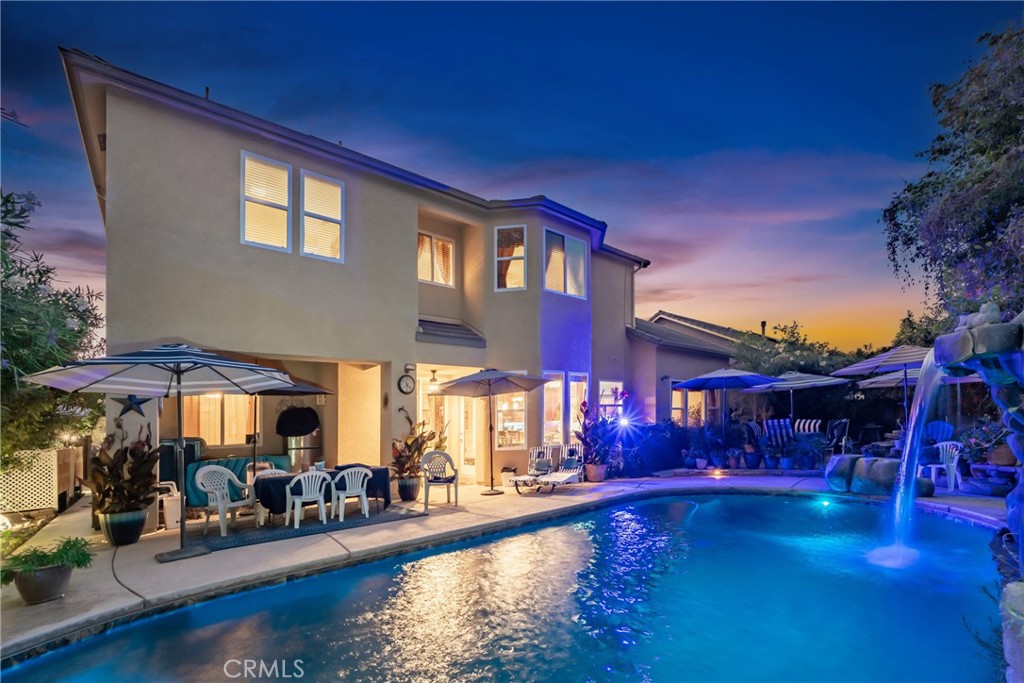 Step into elegance with this spacious 3,443 sq ft, 4-bedroom, 3-bathroom home, offering a beautifully designed living space on an 8,050 sq ft lot & 3 car garage with a blend of luxury, functionality, and comfort. Featuring a chef’s dream kitchen, with premium Thermador appliances, a sous vide stovetop, two induction cook surfaces, four natural gas burners with high-temp fast boil, four ovens & beverage frig. The granite countertops, decorative backsplash, and stainless steel farmhouse sink complete this high-end culinary space. Gaze out the kitchen to admire the resort-style swimming pool with a rock waterfall and spa, perfect for outdoor entertaining. The flexible floor plan includes a bedroom and full bathroom downstairs, ideal for guests or multi-generational living, along with a formal living room, formal dining room, and a cozy den with fireplace. Upstairs, enjoy a large game room with pool table and a 5-speaker ceiling audio system in the family room for immersive sound.