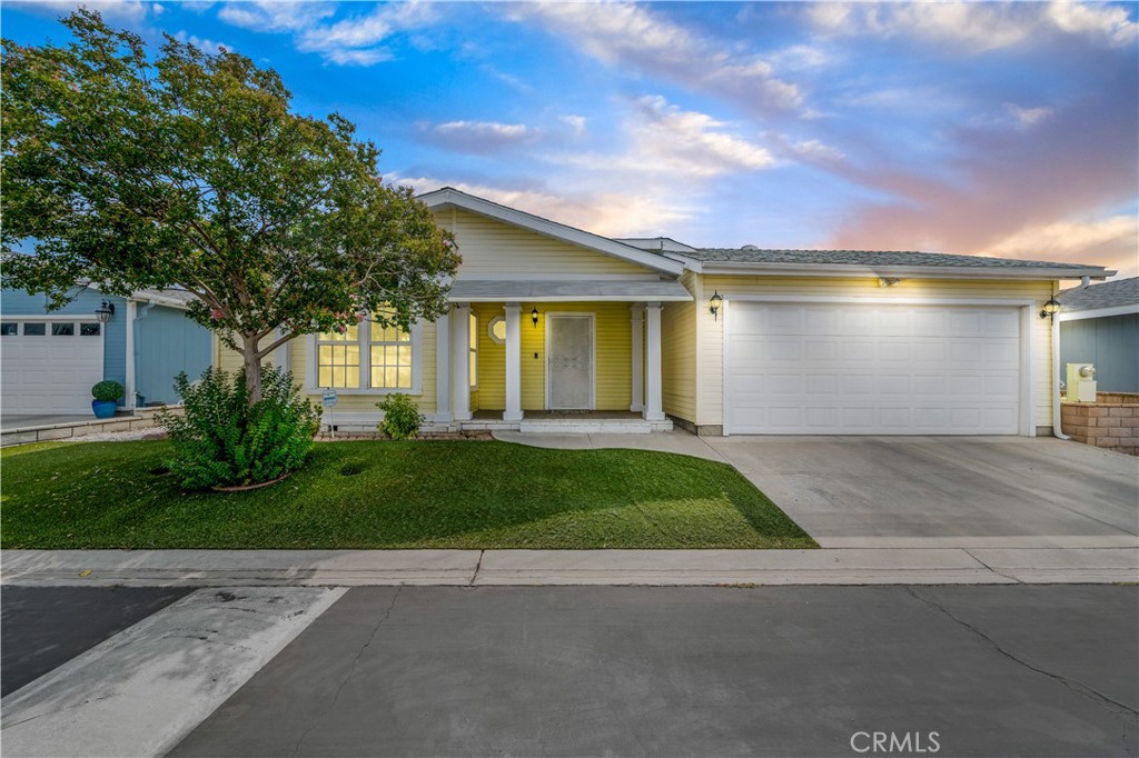 Step into upgraded comfort in Whispering Palms—a welcoming 55+ community where lifestyle and ease intertwine. Situated on its own land and a permanent foundation, this beautifully updated manufactured home offers 3 bedrooms and 2 full baths across a bright, open layout. The refreshed interiors feature stylish finishes and thoughtful touches throughout, from the light-filled living room to the upgraded kitchen with ample cabinetry and modern flair. This stunning light and bright kitchen has been lovingly updated with fresh paint, newer sink and faucet, tile backsplash and all new stainless-steel appliances. A cozy eat-in kitchen nook creates space for coffee filled mornings and everyday enjoyment. Enjoy a separate dining room with tray ceiling off the family room giving it the flow you want for entertaining! The Family room features vaulted ceilings, updated tiled fireplace and wood mantel. Such a great space to cozy up on the couch and enjoy some relaxation. Step outside to your screened-in porch—a peaceful outdoor retreat perfect for sipping your favorite beverage or evening relaxation, all framed by a low-maintenance yard. The spacious primary suite includes an ensuite bath with walk-in shower and deep soaking tub, a walk-in closet for effortless living. Enjoy a dedicated laundry room with ample storage including washer and dryer. The attached 2-car garage adds convenience and storage. Some notable features are new LVP flooring and carpet, crown molding, ceiling fans and fresh paint throughout. Whispering Palms offers residents a resort-style clubhouse, sparkling pool, and a warm community atmosphere with activities to match every pace. With low HOA fees and close access to shopping, dining, and medical care, this move-in ready gem delivers comfort, connection, and California sunshine.