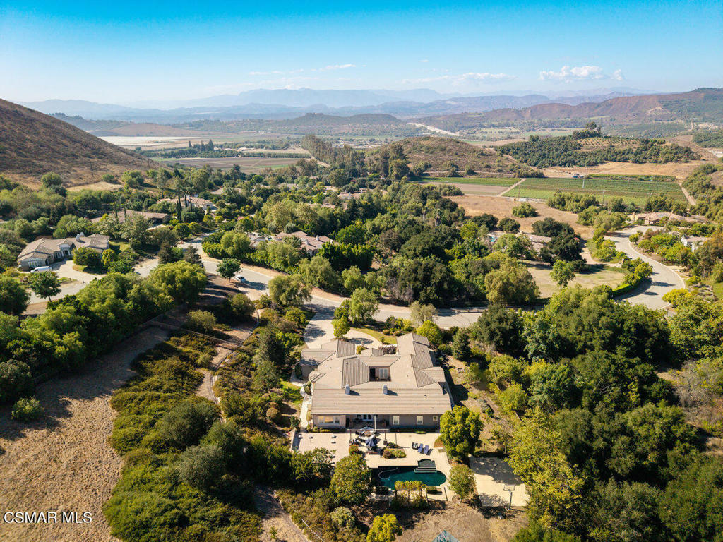 Welcome to this stunning Italian villa estate nestled on over 3 acres with panoramic views. This sophisticated one-story home spans more than 5,000 square feet of elegantly appointed living space. Featuring 4 spacious bedrooms (plus an office that can serve as a fifth), 3.5 baths, a formal living room, dining room, and a chef's kitchen with Sub Zero and Wolf appliances that flows into a large family room with built-ins, it's ideal for entertaining and comfortable living.The home also offers a generous game room, sizable laundry with sink, and a 4-car garage--including maids' quarters and two extra rooms that could serve as media or guest space. The resort-style backyard is equally impressive with exquisite landscaping, artistic water features, a black-bottom saltwater pool with spa and waterfall, sports court with built in adjustable basketball court,This rare single-level villa, defined by Old World charm and a gated atrium, provides a serene, luxurious escape that must be experienced in person.Thank you