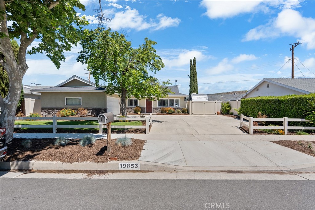 Beautiful single-story home with gorgeous curb appeal, newer stucco and paint, lush landscape, an oversized driveway, and RV parking all within walking distance to Sky Blue Mesa Elementary School! At the heart of the home, you’ll find a thoughtfully designed cook’s kitchen featuring a Fisher-Paykel 36" Cooktop, stainless steel refrigerator, granite countertops, a stainless steel sink, updated lighting, and a large center island that invites both meal preparation and gathering. The kitchen flows seamlessly into the living areas, transitioning from a cool tile floor to updated wood laminate flooring, giving the home both a touch of warmth and a cohesive feel. The family room is anchored by a charming brick accent and new electric fireplace, adding to the home's inviting character. All four bedrooms are spacious with just the right amount of natural sunlight. Dual-pane windows are installed on most windows for energy efficiency and comfort, plumbing has been repiped to copper, and the roof has been updated to include both plank and plywood for additional durability. Both bathrooms have been tastefully updated and are well placed with one of the bathrooms featuring a step-in shower equipped with grab rails. Step outside into your backyard - perfect for kids, pups, or a good book and an evening cocktail. This home is a camper's paradise with large RV parking and updated electrical; making plugging in a breeze (AMP 220). The driveway is huge, and ideal for those with extra vehicles or recreational toys! You'll love the newer durable and eye-catching vinyl fence, storage shed, and the low maintenance artificial turf in both the front and back yard. The garage has been insulated and a split-unit added, making this a great space for a home gym, game room, or additional storage. This home perfectly blends charm and functionality - don't miss out on this rare single level home that has everything you've been looking for - including no HOA!