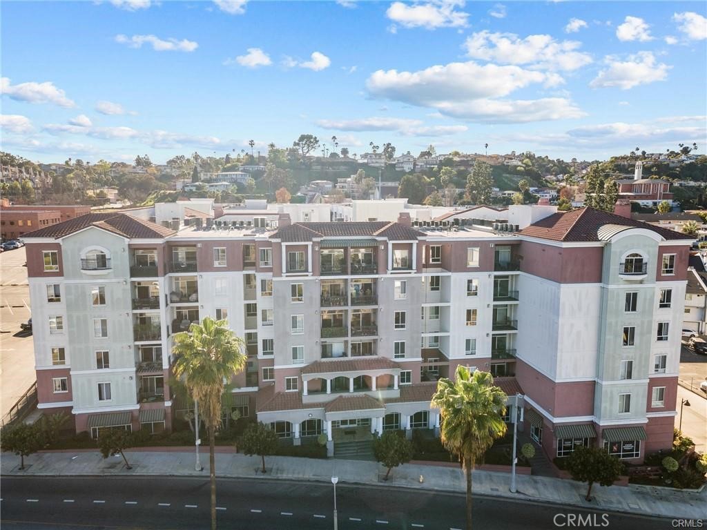 The dream home you've waiting for is here, offering modern luxury living! Beautiful single level condo offers 3 huge bedrooms with walk-in closets, 2 full bathrooms, 2 side by side underground gated parking spots and a big storage room. Relish in the stunning view of the LA Skyline from the balcony. Prepare delicious meals in the gourmet kitchen featuring high-end appliances and much cabinet space. The living room is nurtured by a cozy fireplace and extends to the spacious balcony. The generously sized primary suite provides a private retreat with a full bath with a huge tub, and his/her's walk-in closets. The two additional bedrooms can used for guests and/or office. There is a full-sized guest bathroom in the hallway. In-unit stackable laundry adds to your convenience, central air and heating ensure year-round comfort. As part of the community, you'll enjoy access to an olympic sized pool, a gym, a theatre, a conference area and club house for your business or entertainment needs. Located minutes away from shopping centers, state of the art Kaiser hospital, restaurants and the new metro rail. Experience the resort lifestyle you've been desiring and blessed with as your new way of living!