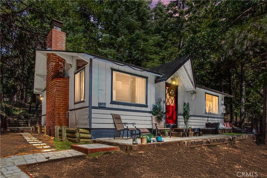 Welcome to 2212 Spring Oak Drive — a charming two-bedroom, one-bathroom mountain cabin set on a peaceful, tree-lined lot in Running Springs. This home blends the warmth of a getaway with the practicality of full-time living (or an excellent income-generating rental). Step inside and you’ll immediately notice the soaring ceilings in the open-concept living room, dining area, and kitchen — the elevated ceiling height opens up the space and makes for cozy, welcoming gatherings. A large fireplace anchors the living room, perfect for chilly mountain evenings. Natural light fills this shared space, especially where the dining area meets the kitchen and streams in through nearby windows. Both bedrooms are comfortably sized, and the full bath is well located. The lot is just over 10,300 square feet, offering privacy and serenity surrounded by mature trees. Built in 1968, the cabin has been thoughtfully updated with some cosmetic refreshes, yet it keeps a rustic, mountain feel. Location is a dream: minutes from Lake Arrowhead, close to Santa’s Village, and about 20 minutes down the mountain to Highland. So you get the peace and beauty of the mountains without being too far from everyday amenities. Whether you’re looking for a weekend escape, a full-time mountain life, or a rental property with appeal, this home offers versatility. Private. Serene. Ideal.