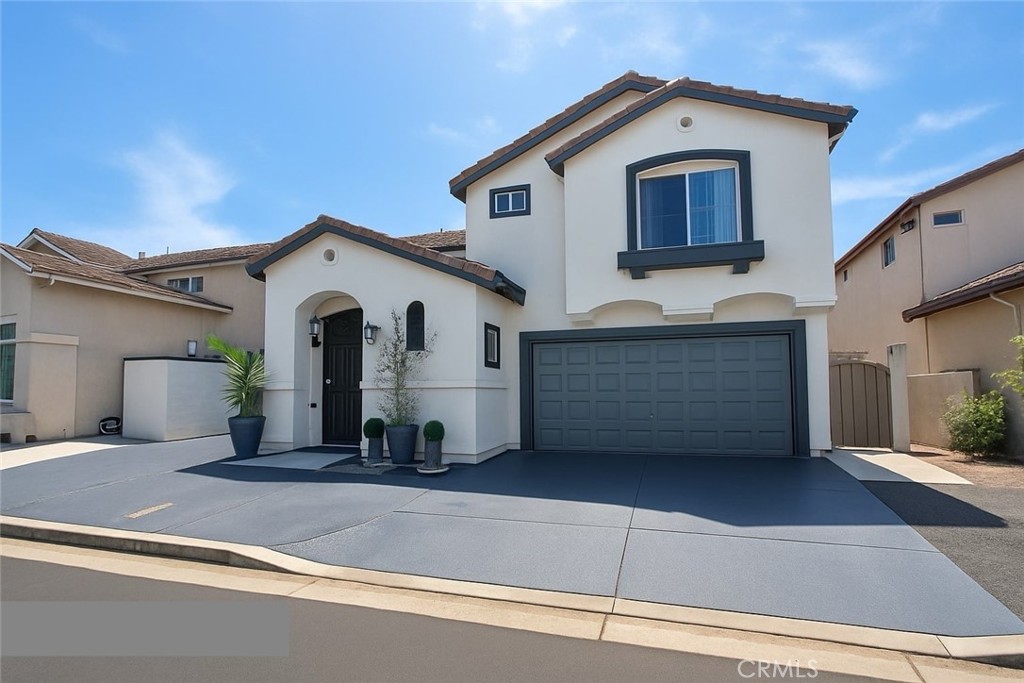 Beautifully remodeled Garden Grove home with modern upgrades offers 4 bedrooms, 2.5 baths and 2,000 square feet of living space. This two story home features well appointed high ceilings and a spacious loft. All four bedrooms are located upstairs, providing privacy and a quiet retreat for family members, while a convenient half bath on the main floor serves guests and complements the open living areas. The additional loft area can be utilized as a home office, study space, or a cozy lounge. The newly remodeled kitchen showcases wall-to-ceiling white cabinets, quartz countertops, and a waterfall-style island for additional seating and storage space. Just off the kitchen, the large, well-designed dining area can accommodate large family gatherings, ideal for holiday dinners, or entertaining friends. Each bathroom has been updated with high-quality finishes, creating a fresh and contemporary appeal. Step outside through the elegant foldable patio door to a backyard designed for both style and comfort. The custom stonework highlights the newly installed aluminum patio cover with stylish patio fans creates a sleek, contemporary outdoor living space—perfect for gatherings, entertaining, or relaxing in the shade. Additionally, the finished driveway enhances the property’s curb appeal along with new exterior paint gives the home a contemporary look and welcoming touch. Schedule your private tour today and make this dream home yours!