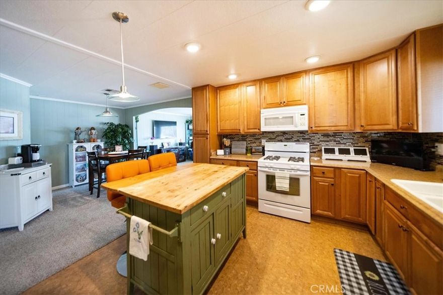 You own the land with this quality, Turnkey, home! It boasts a Spanish Tile Front Patio, that carries on into the front door entry way. Or enter in through a set of wide French Doors conveniently located just near the kitchen. The Kitchen, with its Under Cabinet Lighting and Recessed Lighting provides for a spacious open floor concept - perfect for entertaining. When relaxing in the Family Room, the oversized windows provide for an abundance of natural sunlight, and the home will stay cool with Ceiling Fans installed throughout. The home offers two very spacious bedrooms, while the Master Bathroom provides a Dual Sink Vanity. Your new home includes Free Golf for 2 residents, Pools, Hot Tubs, Tennis, Pickle Ball, and a Club House all included in the HOA. The property comes fully furnished as is.