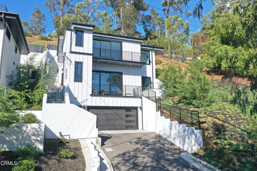 Nestled at the end of a quiet and serene cul-de-sac, just moments from Pasadena and with convenient access to Los Angeles' major arteries, this newly constructed, three-story home exemplifies luxurious living. With chic contemporary design, natural lighting, and stunning city views, it offers a rare opportunity to enjoy a modern lifestyle in a highly desirable location. Step into an open-concept living space perfect for entertaining. Blonde Oak hardwood floors flow throughout, complemented by recessed lighting and expansive LaCantina 3 panel sliding glass windows that frame breathtaking views. The state-of-the-art kitchen features sleek Calacatta porcelain countertops, a bookmatched Calacatta porcelain backsplash, brand-new stainless steel Thor appliances, a wine fridge, and an island with ample space for dining and meal preparation. Adjacent to the kitchen is a versatile bedroom with a full bathroom, ideal for use as an office, gym, or guest room. A convenient half bath is also located on this level. The second floor hosts the luxurious primary suite, complete with a walk-in closet, large LaCantina 3 panel sliding glass windows, and a private indoor-outdoor terrace. The spa-like primary bathroom includes a soaking tub for ultimate relaxation and a walk-in shower with bookmatched porcelain slabs. A secondary bedroom with its own full bathroom and a dedicated laundry area complete this floor. The top level boasts a shaded patio, perfect for dining and entertaining. A short staircase leads to the rooftop deck, offering panoramic views of Los Angeles and the Downtown LA Skyline. With water and gas hookups, the space is ready for an outdoor kitchen or grill, making it ideal for hosting gatherings under the stars. Additional features include dual zone central air/heat, recessed lighting throughout, built-in wine cabinet under staircase, built-in ceiling speakers, solar panel ready on the rooftop, and an attached 2 car garage. This home is conveniently located near the 110 Freeway, Pasadena, excellent schools, and a variety of shopping and entertainment options. Don't miss this exceptional opportunity to own a meticulously designed, move-in-ready home where comfort, style, and convenience come together.
