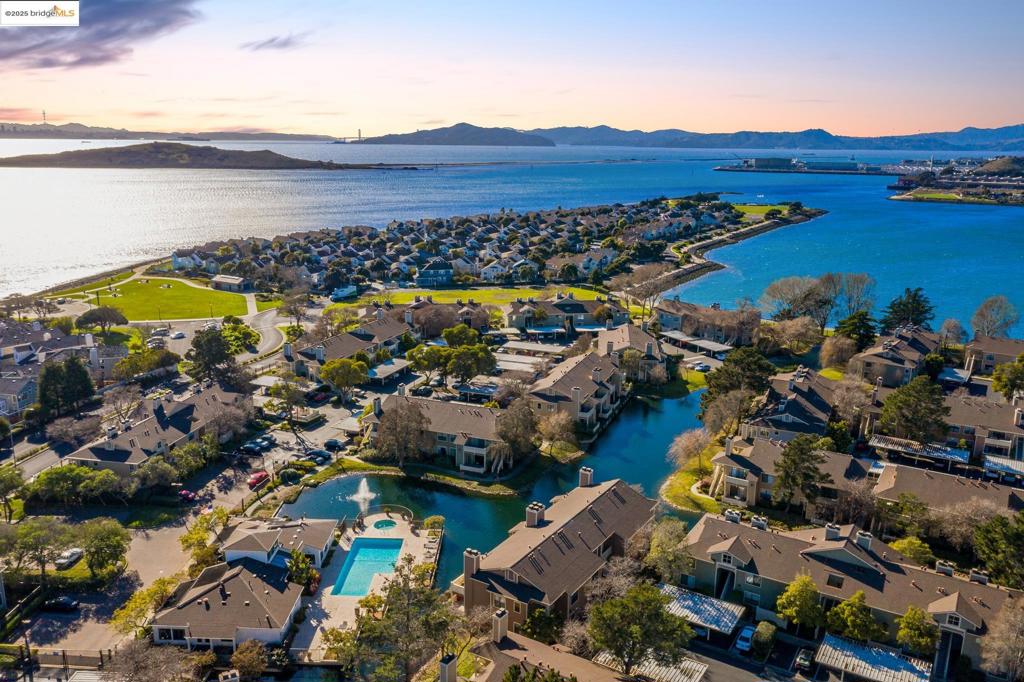 California Coastal Living in Marina Bay! Welcome to 15 Shoreline Ct, a rarely available lagoon-front end-unit condo with serene water views. This ground-level home features an open floor plan, extra corner windows for abundant natural light, and a stylishly upgraded kitchen with quartz countertops, stainless steel appliances, and modern fixtures. The spacious bedroom includes dual closets, while the living room offers a cozy fireplace. Convenience continues with in-unit laundry and nearby gated access to resort-style amenities. The HOA offers exceptional amenities, including secure entry, assigned parking, heated pools, hot tubs, a state-of-the-art fitness center, and a community clubhouse. The location is unbeatable—just minutes to 580/80, BART, Berkeley, Oakland, Marin, and within walking distance to the SF Ferry. Outdoor enthusiasts will love the Bay Trail, steps away, which is perfect for cycling, running, sailing, or simply soaking in the beauty of Marina Bay. This home is more than a condo—it’s a lifestyle.