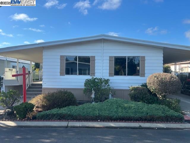 Nice mobile home in New England Village (adult park) has: 2 bedrooms; 2 full baths; open kitchen with breakfast bar; open living and formal dining room; dining area with built in hutch; separate family room with slider to porch and display area; laminate flooring in most areas; primary suite with 2 closets and private bath with walk in shower 2 sinks and storage; indoor laundry room with washer, dryer, and utility sink; large front porch; some private yard space; AC Unit; shed; deck area for sitting; close to visitor parking & more. Fireplaces: NO