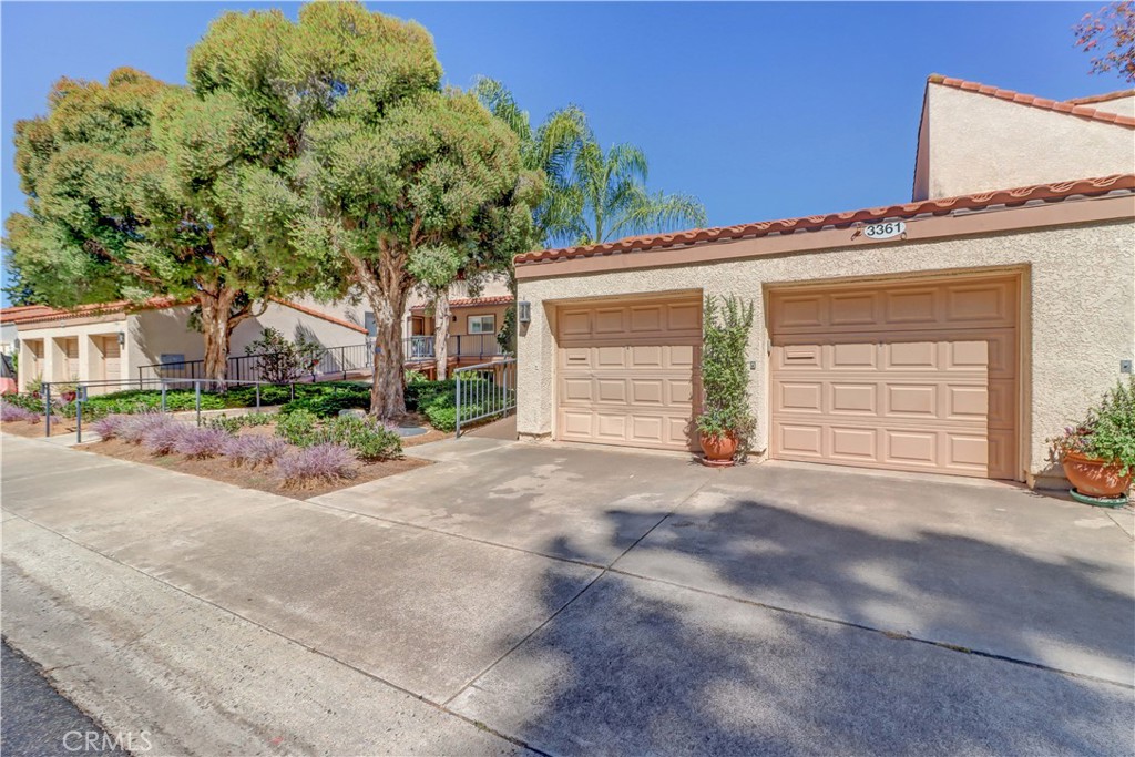 Spacious end-unit "Catalina" upper level CONDO with NO STEPS, 1 car garage + driveway, great view and close to Clubhouse 5. Brand new flooring throughout and fresh coat of paint. Bright kitchen features Corian countertops, sunny west facing window over the kitchen sink, dishwasher, refrigerator with bottom-loading freezer and a built-in microwave. Large living room area is accented with a wood-burning fireplace, beautiful mantle and a lots of windows/sliders to enjoy the great view. Step right out onto your lovely east facing balcony area with room to sit and enjoy the surroundings and the morning sun! Two good sized bedrooms, primary features long dressing area with ample closet area. Guest bath has a tub/shower combo and master bath has stall shower. Full-size washer/dryer included. Quiet, single loaded cul-de-sac. Just down the hill from Clubhouse 5 which hosts club meetings, dinners, dances and entertainment, billiard room, game room, lounge area and swimming pool with aquatic classes. Laguna Woods Village residents enjoy a 27-hole championship golf course, a 9-hole executive par 3 course, pickleball and tennis courts, lawn bowling, gyms, clubhouses, swimming pools, horse stables, gardening centers, artist studios, computer workrooms and classes + over 200 clubs and organizations.