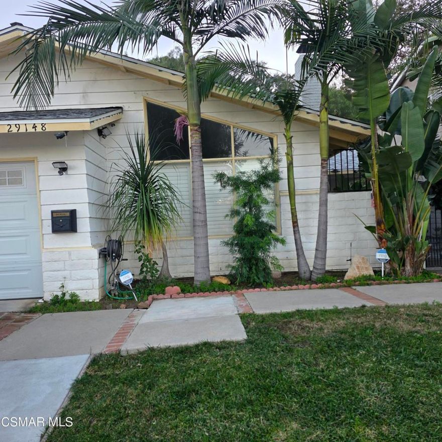 Extremely well-priced opportunity located within the highly regarded Las Virgenes School District, in close proximity to Agoura High School and Willow Elementary School.This beautiful home in Agoura Hills offers a rare combination of privacy, comfort, and access to one of Southern California's most desirable family-oriented communities. The property features 4 bedrooms, 2 bathrooms, and approximately 1,660 square feet of thoughtfully laid-out living space, with recent updates that enhance both comfort and functionality.Upon arrival, you are welcomed by a private front patio, fully enclosed by a block wall and wrought-iron gate, creating a quiet and secure entry. Inside, the home opens to a spacious living and family room with high ceilings, a fireplace, and abundant natural light, making it an ideal gathering space. A formal dining room with high ceilings is conveniently located adjacent to the kitchen, offering excellent flow for everyday living and entertaining.The home features wood-like flooring throughout, with tile in the bathrooms and laundry room. The hallway provides generous storage and closet space, an important and practical feature. The primary bedroom is well positioned and offers newer flooring, custom shuttered closet doors, surround sound speakers mounted above the ceiling with receiver, and a private en-suite bathroom. Windows overlook the backyard and surrounding Agoura Hills landscape, creating a peaceful and relaxing setting.The three additional bedrooms are well proportioned and include ceiling fans, good natural light, and ample closet space, with flexibility for use as guest rooms or a home office. A Ring security system is included, with coverage at the front, back, and interior of the property.The kitchen features a double sink and ample cabinetry, and the home includes an indoor laundry room with a large sink and space for a washer and dryer. A 220-amp line has been installed to the backyard, offering future flexibility, and the rear yard includes a gas BBQ island with burner and refrigerator.Major system upgrades include new air conditioning and ductwork installed in 2024 per seller, and the roof is in good condition.The location is a significant advantage. The property is close to shopping, dining, and daily conveniences, with three major shopping and entertainment centers within five minutes, including Whizin Market Square, Canyon Club, art galleries, and top restaurants. Nearby centers include Vons, Ralphs, Kanan Center, and Agoura Deli. The area offers numerous parks and recreational options, access to hiking trails, and proximity to Malibu Creek State Park. Malibu beaches are approximately 15-20 minutes away, while Westlake Village dining and entertainment are just minutes from the property.Homes in this area continue to attract strong interest due to quality schools, neighborhood stability, and proximity to amenities. This property represents a solid opportunity in a highly desirable Agoura Hills location.