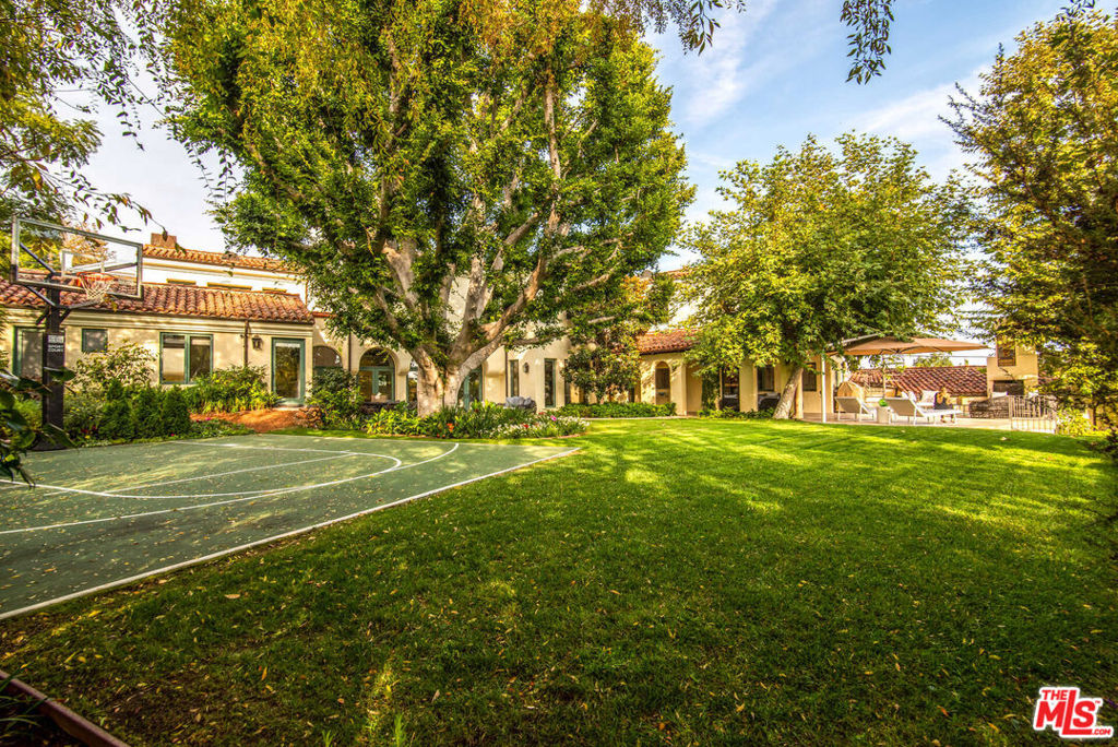 This custom-built Spanish estate has 5 bedrooms, 5 bathrooms and is located moments away from Palisades Village. There is a fabulous updated cook's kitchen and bright living room with high ceilings and French doors that open up to a beautiful patio, perfect for entertaining. The primary suite has its own private balcony with views of the ocean and a sumptuous spa-like bathroom retreat. Other unique features include a dramatic two-story wing that can be used for screening, workouts, or entertaining. The large private park-like backyard comes with a 63-foot swimmers pool, spa, and a basketball sports court. This stunning home also offers a rare attached four-car garage. Don't miss out on this rare opportunity. Location, location, location.