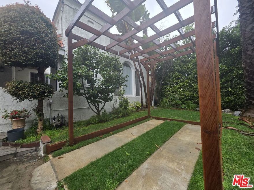 charming, updated large 3 bd/2.5 bath traditional single-family home in the heart of Miracle Mile, set on a quiet, tree-lined street. This one-story attached residence is bright and airy with hardwood floors, high ceilings, and large windows throughout. Features include an updated kitchen with quartz countertops, modern appliances, in-unit laundry room,  and a decorative fireplace in the living room. The property offers a gated driveway with parking, private entry, and a peaceful residential feel. Unfurnished, and conveniently located near The Grove, Original Farmers Market, LACMA, with easy access to central Los Angeles.