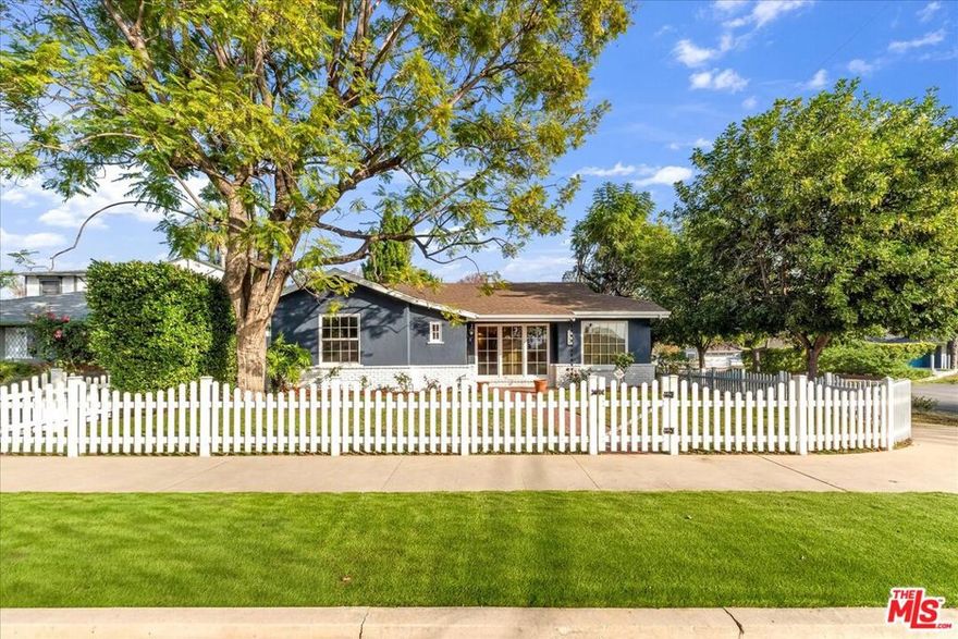 NEW PRICE! Completely Renovated. Welcome to this storybook Sherman Oaks retreat, gracefully set on a sweeping corner lot framed by a classic white picket fence. Behind its charming gates lies a single-level traditional home of nearly 2,000 sq. ft., featuring 3 bedrooms (currently the 3rd bedroom is being used as a convertible den with a fireplace and its own entrance), 2.5 baths, all thoughtfully designed for both comfort and style. Inside, vaulted wood-beam ceilings and dual brick fireplaces create an atmosphere of warmth and timeless appeal, perfectly complemented by pristine oak hardwood floors and a seamless center-hall layout. The spacious living and dining room are wrapped in sunlight and garden views, offering the ideal flow for relaxed entertaining or cozy nights in.The primary suite rests quietly at the back of the home, overlooking a tranquil garden oasis complete with fruit trees, an outdoor dining patio, and peaceful sitting areas. The den, with its own fireplace, connects effortlessly to a brand new kitchen, a cheerful breakfast nook, and a full-sized utility room with an additional guest bath. Every room tells a story of comfort and ease, from the window-wrapped dining room to the versatile detached two-car garage, ready to become your studio, gym, or creative space. A home that feels like an escape, yet sits right in the heart of Sherman Oaks, this is where classic California charm meets everyday livability. Come experience it for yourself and fall in love with your next home. Submit on pets. Pet acceptance is at the sole discretion of the R.P.O. Guest unit on property being leased separately for $3,500/month.