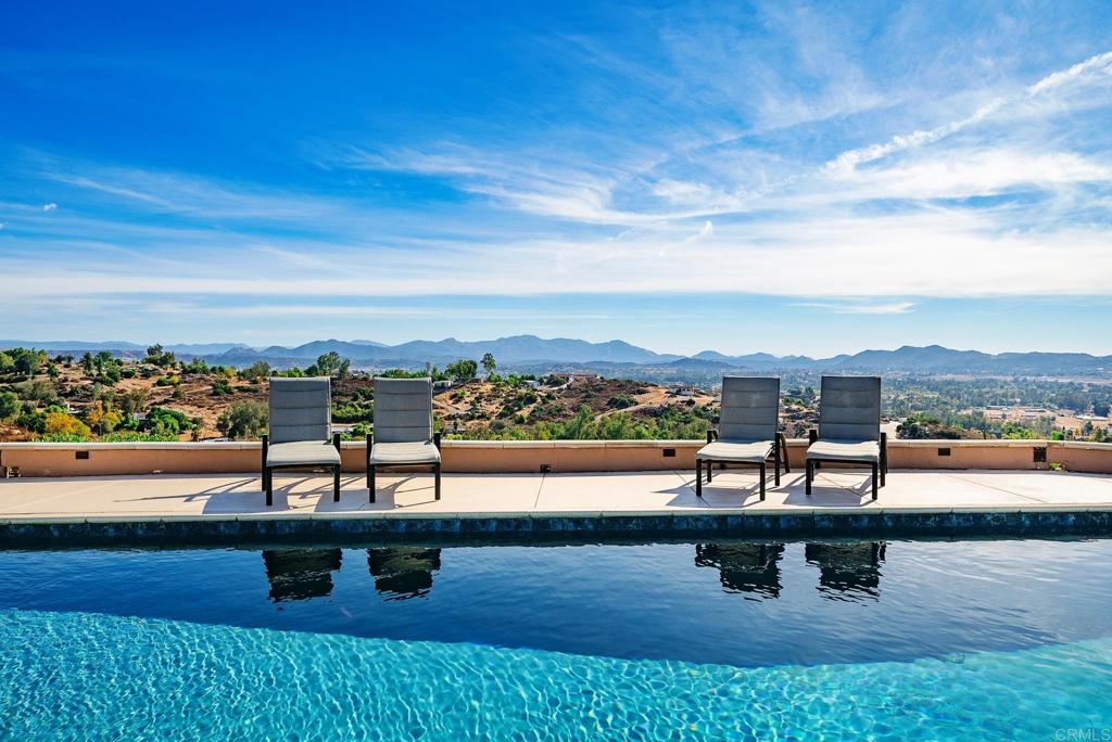 You can't find another home like this one! This home has everything. SPECTACULAR mountain and valley VIEWS, DETACHED ADU/AIR BnB that has brought in an extra $3000 month. Inground POOL and SPA, 3 CAR attached garage + DETACHED SHOP, underground storage container, WELL and CITY WATER. RV PARKING W/HOOK UPS and room for toys on nearly 6 acres. Adjacent to THOUSANDS of ACRES of Open Space/Grasslands. This custom home has a formal courtyard entry with pond, breathtaking views from almost every room, 9' and vaulted ceilings, light and bright with tons of windows to enjoy the view. If that is not enough, there are avocado, lime, grapefruit, orange and meyer lemon trees.