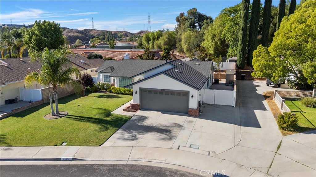 Welcome to this wonderful single-story home tucked into a quiet Santa Clarita cul-de-sac with no HOA and no Mello Roos! From the moment you walk in, you’ll notice the bright, open feel thanks to vaulted ceilings, a big bay window in the dining area, and a cozy fireplace in the living room. The kitchen has been tastefully remodeled with quartz counters, a spacious island, tile backsplash, and sleek stainless appliances - perfect for everyday cooking or gathering with friends.
The home has new luxury vinyl plank flooring throughout, recessed lighting, and a roomy primary suite. French doors lead out to a covered patio, a lovely space for a dining table - perfect for those al fresco mealtimes - and a private yard with perfectly manicured greenery.
Practical updates include a newer roof, rain gutters, HVAC system, and a whole house fan for extra cooling. The garage is fully finished with drywall and coated flooring, making it both functional and clean. You’ll also find smart-home features like a Ring doorbell and app-controlled thermostat.
Need extra space? There’s gated RV parking on the side of the house too!
This home blends comfort, style, and convenience — all in a great neighborhood setting.