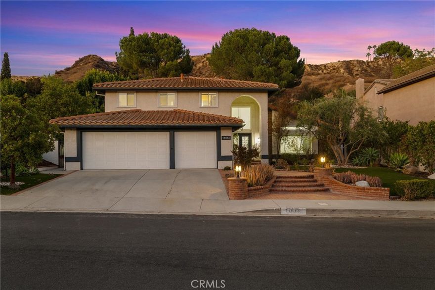 Dreaming of Living in Porter Ranch? This 3-Bedroom Pool Home Has It All! If you’ve been considering a move to Porter Ranch, this is the home you’ve been waiting for. Located in one of the most sought-after neighborhoods, this updated Porter Ranch home for sale offers over 2,646 sq. ft. of open living space, a sparkling pool, spa, large backyard, and mountain views for both comfort and style. 

Walk inside through the double wrought iron doors, and you will be greeted by high-end designer wrought iron staircases—a true showstopper. To your right, high ceilings allow an abundance of light to brighten the living room, which leads to the formal dining room. The custom fireplace will not go unnoticed, and the picture-perfect window overlooks the lush landscaping.

The open floor plan connects to a formal dining area and a beautifully updated kitchen featuring a large center island, custom backsplash, stainless steel appliances, and an eat-in area. The adjacent family room boasts a custom stone fireplace that complements the overall house design, adding an elegant touch.The huge remodeled kitchen showcases quartz countertops, an induction cooktop, custom cabinetry and backsplash, stainless steel Bosch appliances, a beverage center with a small U-line refrigerated cooler, an overhead cooking exhaust fan, an eat-in area, a walk-in pantry, and a breakfast bar.

Heading to the second floor, you’ll find an extravagant master suite and a remodeled private bath with a walk-in closet, dual sinks, and a separate soaking tub, balcony enjoying the views. Bathroom upgrades include newer sinks, tubs, tile, and flooring. Your backyard features a pool and spa with a newer pool heater and variable-speed filter, a built-in BBQ, an adjustable-height basketball hoop, fruit trees, and a garden. Additional amenities include hardwood flooring, a split system HVAC with separate heat/cooling Mitsubishi units upstairs, a whole-house attic fan, and insulated garage doors. 

Located just minutes from hiking trails, parks, and The Vineyards at Porter Ranch, and within the boundaries of top-rated schools including Castlebay Lane Elementary, Frost Middle School, and the award-winning Granada Hills Charter High School, this is your chance to experience the best of living in Porter Ranch.