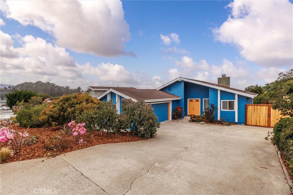 Charming Beach Bungalow – Embrace coastal living in this inviting single-level home, ideally situated on a quiet cul-de-sac near hiking trails and just minutes from Montana de Oro State Park, Sea Pines Golf Resort, and the Monarch Butterfly Preserve. The master suite features a spacious tiled shower and a sliding door leading to a beautifully landscaped backyard. A second bedroom is served by a full bath with a convenient walk-in tub. Vaulted ceilings, a stone fireplace, a bright sunroom, and durable laminate flooring create a warm, open atmosphere. Additional amenities include an attached two-car garage with laundry, gated side-yard parking for extra vehicles or recreational gear, and a reduced sewer assessment. Bayview potential for future improvements.