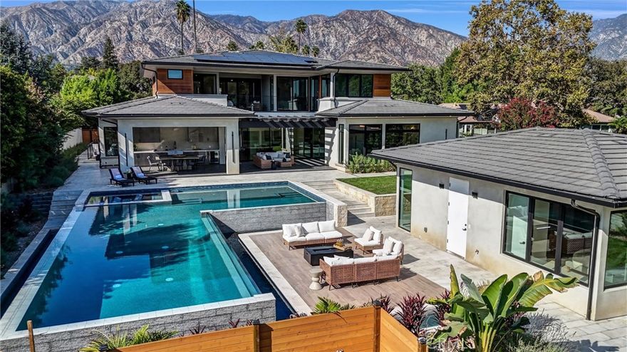 Half an acre of perfection! This completely reimagined property includes a NEW CONSTRUCTION contemporary masterpiece, drought-friendly landscaping, PAID OFF solar roof panels (nearly NET ZERO!), a backyard oasis and a bonus ADU/pool house. No expense spared! 





Step inside through the stunning pivot front door and you’ll find wide-plank hardwood floors, dramatic double staircases and soaring ceilings. Every room here includes beautiful tilework, gorgeous fixtures and custom millwork.  





The main level has an open layout that’s filled with natural light. The chef’s kitchen anchors the rear of the floorplan, complete with sleek European cabinetry, top-of-the-line Wolf & Sub-Zero appliances, two porcelain-topped islands and a scullery. The kitchen is open to the living room and dining room, which includes a climate-controlled wine cellar. When the weather’s right, you can open the massive glass pocket doors to truly maximize indoor/outdoor living. 





In that backyard oasis, you can entertain under the pergola, dine in the lanai under the built-in infrared heaters, or gather around the poolside firepit. The infinity-edge spa & pool has to be seen in person! The ADU/poolhouse includes a kitchen, bedroom & bathroom – with all the same high-end materials found in the main house. 





Back in the main house, there are two master suites – one upstairs and one downstairs. Both spa-like ensuites are simply stunning, offering porcelain slab walls, his&her vanities, a free-standing soaking tub and a gorgeous frameless glass shower. Each of the guest bedrooms also includes a private ensuite. 





Still need more space? Head down to the lower level, where you’ll find a large game/rec room, a gym/home office, a home theater, a guest room and a bathroom. Even the basement has private outdoor space! Don’t forget about the 4-bay garage and the solar roof panels on Net Meter 2.0 – which nearly eliminates all your utility bills!



 



Nestled in the foothills of the San Gabriel Mountains, this neighborhood puts you close to everything – hiking trails, the 210 Fwy, Pasadena, Santa Anita, the Arboretum and more. The area is zoned to the award-winning Arcadia school district, and you’ll be just minutes from all the shopping & dining along historic Rt 66.