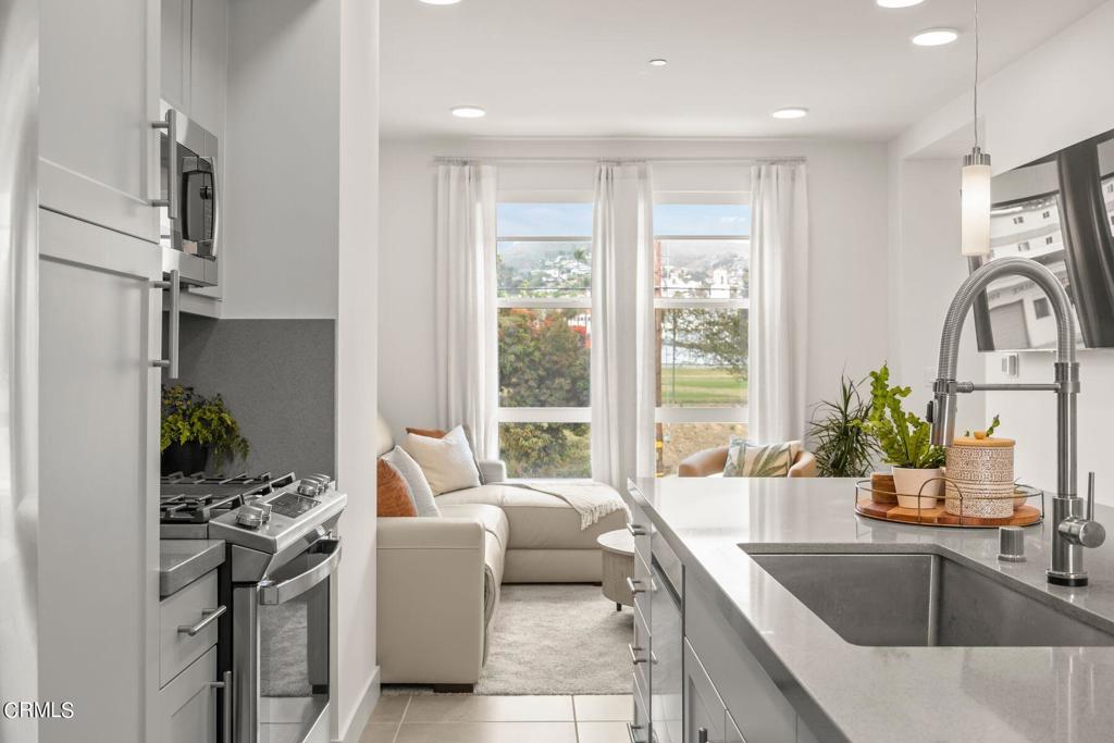 This bright and breezy tri-level townhome offers 3 bedrooms, 4 bathrooms, and ~1,500 sq ft of thoughtfully upgraded living space -- including a rare layout with a bedroom and full bath on every level, perfect for guests, privacy, or flexible living.As a corner unit, it's drenched in natural light and features three outdoor decks -- ideal for morning coffee, sunset cocktails, or working from home in the coastal air. Inside, you'll find designer tile, premium quartz countertops, custom cabinetry, and an open kitchen with an oversized island and seating for six. The main living space is elevated and open, with tinted windows that keep things cool and private without blocking the view.Central A/C, a tankless water heater, and in-unit laundry bring comfort and convenience, while the HOA covers trash, earthquake insurance, and exterior maintenance.Just a 1/4 mile from the beach, promenade, and downtown -- it's walkable, livable, and packed with lifestyle.At $975,000, it's one of the best buys near the coast. Come see why Ventura is California's favorite hidden gem.