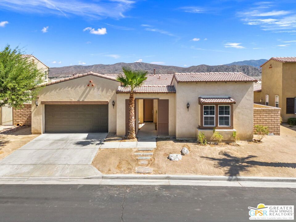 Welcome to 82590 Cray Mill Dr, a beautifully maintained single-level home located within the gated community of Sonora Wells in Indio. This 3-bedroom, 2-bathroom residence offers 1,841 square feet of thoughtfully designed living space, making it an ideal choice for a family seeking comfort, privacy, and a sense of community. The open-concept layout features a spacious living area filled with natural light, a dedicated dining space, and a well-appointed kitchen with granite countertops, ample cabinetry, and a center island perfect for family meals or entertaining. The primary suite is generously sized and includes an en-suite bathroom with dual vanities, a soaking tub, and a walk-in closet. Two additional bedrooms are positioned to offer privacy and flexibility, ideal for children, guests, or a home office. The home also includes a separate laundry room and an attached two-car garage for added convenience. The backyard is currently lacking landscaping, providing a blank canvas for tenants who may wish to customize the space to their liking or simply enjoy it as-is with virtually no maintenance required. While tenants are responsible for yard service, there is currently nothing to maintain, as shown in the listing photos. Sonora Wells is a private, family-friendly community offering residents access to seven parks, a resort-style pool and spa, walking paths, BBQ areas, and a dog park perfect for daily activities and weekend fun. This property is available for a minimum one-year lease. Tenants are responsible for all utilities, including yard maintenance. Available now, discover the comfort and convenience of long-term living in one of Indio's most desirable gated communities.