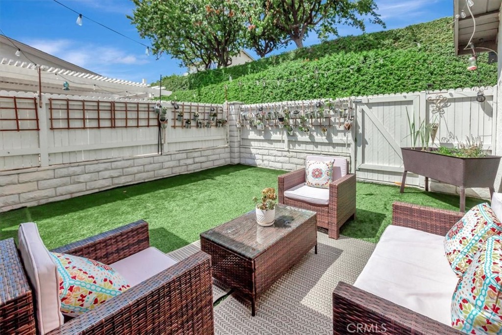 Detached single story condo, beautifully updated, move-in ready in the Woodgate community of Yorba Linda! This spacious, bright home features three bedrooms and two bathrooms with an open layout, high ceilings, and thoughtful upgrades throughout. Major updates completed in 2022 include new flooring, double pane windows, recessed lighting, new air ducts, new water heater, water softener, and a smart thermostat for year round comfort. You'll also appreciate modern touches like a smart door lock, Ring doorbell, and new doors, baseboards, and fresh interior paint. The kitchen features updated appliances, a functional peninsula, and an eat-in dining area, opening to the backyard through a sliding glass door, perfect for indoor-outdoor living and entertaining. The attached two car garage now includes a utility sink for added convenience. This home comes equipped with a Tesla charger, offering convenient and eco friendly charging right at home. The primary suite offers private access to the backyard, you'll love the low-maintenance turf in both the front and backyard, ideal for relaxing with family or hosting friends. Enjoy the peaceful lifestyle that comes with living in Woodgate, with community amenities like a pool, spa, clubhouse, tennis/sports court, and a lush park, well maintained by the HOA. Located just minutes from the 91/55 freeways, Toll Road, Yorba Regional Park, and great shopping and dining at Savi Ranch and the new Yorba Linda Town Center. The home is zoned for top-rated schools in the Placentia-Yorba Linda Unified School District, including Glenknoll Elementary and the Orange County School of Computer Science at Bernardo Yorba. With all the updates, unbeatable location, and excellent schools, this home truly checks all the boxes!