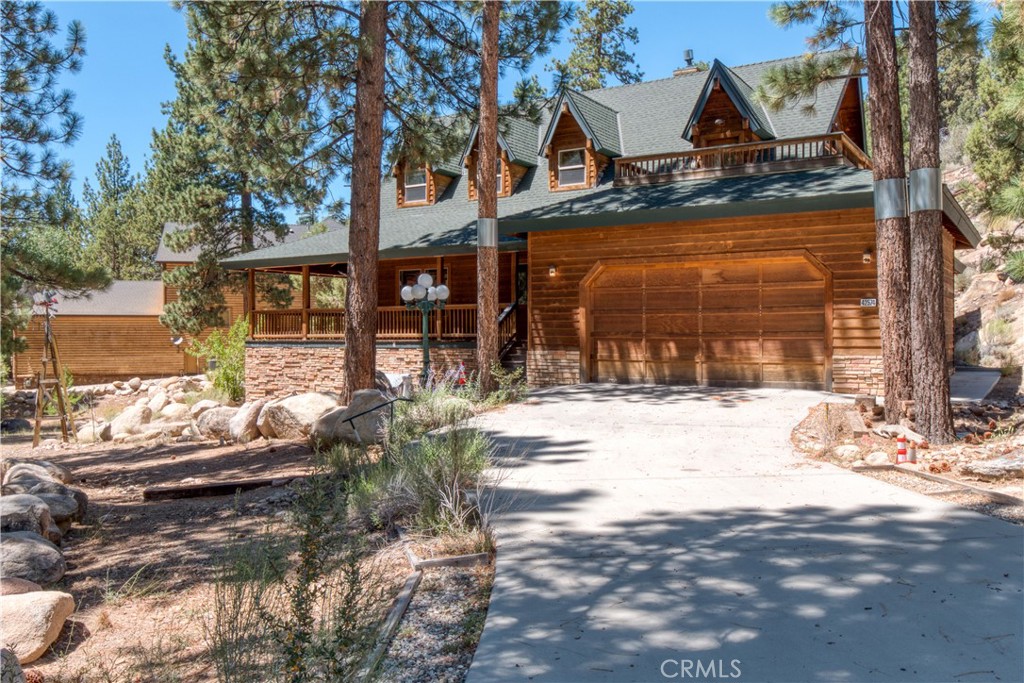 Nestled back from the street, this Eagle Mountain Estate Home sits on a large lot ideally situated to be a tranquil retreat from the hustle and bustle of city life. Custom built from the ground up in 2005 by original owner. Wrap around covered deck. Wood laminate floors throughout. Carpet in bedrooms and stairway. Spacious ground floor primary suite with walk-in closet leading to a sunroom where one can observe the natural wonder this lot has to offer. Well appointed kitchen with island, and additional sink next to oven. Open to Family/dining room with decorative wood burning oven to add a touch of classic charm to this living space. Large living room with fireplace and high ceilings. Laundry area on ground floor. Oversized 2 car garage with long driveway. Upstairs there are 3 bedrooms, one with private patio. Lots of storage space. Loved for many years by one owner. Ready for a new owner to spruce it up & make it their happy place for many years to come.