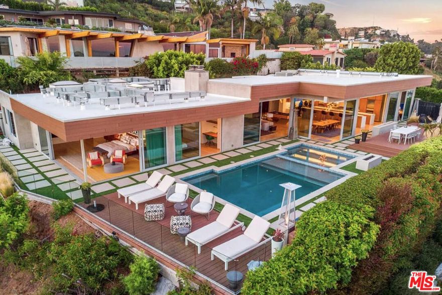 Fully Furnished and Ready to Move In  Nestled in the prestigious hills above the Sunset Strip, this chic modern residence at 1429 Devlin Dr delivers the ultimate LA lifestyle. With breathtaking city views, a seamless indoor-outdoor flow, and curated designer interiors, every detail has been thoughtfully crafted for elevated living and effortless entertaining.Set behind a private gate on a 12,374 sq ft lot, the home features 4 spacious bedrooms, 5 bathrooms, and an open-concept layout flooded with natural light. The gourmet kitchen includes top-of-the-line appliances, sleek cabinetry, and an oversized island that anchors the main living space. Expansive glass doors open to a tranquil outdoor oasis complete with pool, spa, sun deck, and al fresco dining areas, all facing the glowing city lights.The west-facing orientation ensures magical sunsets and golden-hour ambience throughout the day. Built in 1960 and recently updated with modern amenities, this home blends timeless architecture with contemporary sophistication.Whether you're looking for a luxe short-term escape or a long-term sanctuary, this turnkey property comes fully furnished with curated pieces, luxury linens, and everything you need to move in and start living. Moments from Soho House, Beverly Hills, and all the best of West Hollywood. Approx. 12,374 sq ft lot | Private | Gated | Designer done