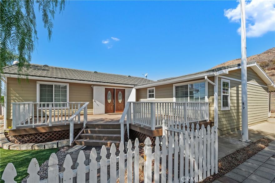 COUNTRY LIVING  at it's very best..  Welcome to 23742 Bundy Canyon Rd., located on a hilltop, a fully remodeled Manufactured home on an incredible 5 Acres. With breath taking  forever views and gorgeous sunsets....   Beautiful 4 Bedrooms, 2 1/4 Baths,  Living Room, Family Room, Dining Room, and Den/Home Office could be 5th bedroom...    The Kitchen is a chef's dream, featuring granite counters, custom white cabinets, and newer appliances.  There are unlimited possibilities on this 5 Acre property for a homeowner with vision.  Ceiling fans, canned lighting, including new window blinds throughout.  This home has an open flowing floor plan with laminate and tile flooring.  Step outside to a huge gated front porch with double door entry as well as a rear covered porch and patio.  The 2 car garage is detached. Fireproof Metal Roof.  .  Another huge feature is the  newer massive permitted Approx.  2550+  Sq FT   Steel Storage  Bldg. / Shop/ RV Parking/Boat / Plus Toys... This property is ideal for commuters, large families, and is located between the I 15 and the I 215 freeways.   Home is on a well, septic and propane.   Low, Low Taxes  and no HOA....