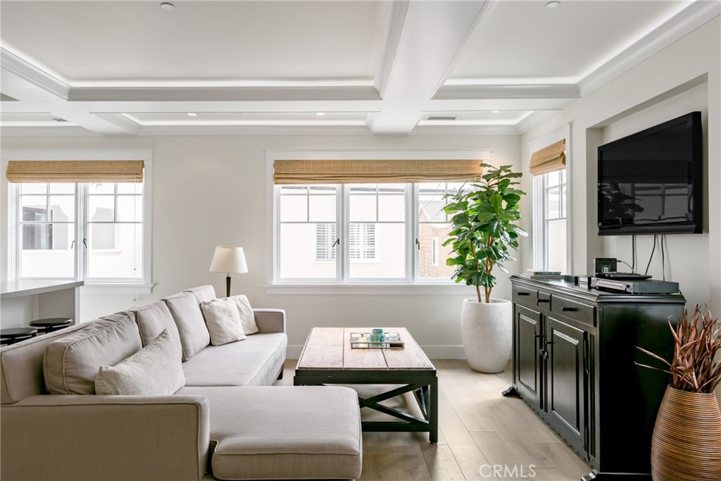 This unfurnished 2-bedroom, 2.5-bath residence blends modern luxury with timeless coastal charm. Enter through your private entrance and be greeted by warm wood floors, crisp white walls, and sleek finishes that set a sophisticated yet inviting tone.
Upstairs, the main living area is bathed in natural light from expansive windows, while the open-concept design and stunning coffered ceilings create an airy, elevated feel. The chef’s kitchen impresses with stainless steel appliances, designer pendant lighting over the island, and elegant grey quartz countertops. A stylish half bath nearby pairs classic subway tile with a modern vessel sink and polished chrome accents.
The spacious guest bedroom offers room for two beds, large windows, and its own en suite bathroom for added comfort. The primary suite is a serene retreat, featuring vaulted ceilings, a private balcony, and a generous walk-in closet. Its spa-inspired bathroom includes a soaking tub, a large walk-in shower, and vaulted ceilings for a touch of grandeur.
Convenience meets style with in-unit laundry, while the unbeatable location places you in the heart of Corona Del Mar—just minutes from Fashion Island, Corona Del Mar State Beach Park, Newport Country Club, and more.