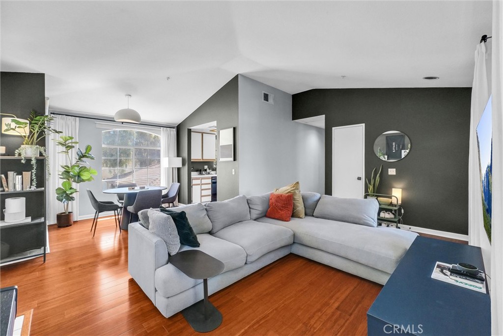 This well-maintained CORNER townhome sits in the sought-after community of Shadow Canyon – on the edge of the Tustin Ranch Golf Club.
The upper-level home welcomes you with a large front porch and treetop views. Inside the front door, you'll find vaulted ceilings, a fireplace and beautiful hardwood flooring throughout (no carpets here!). And since this is a corner unit, two walls of windows fill the home with natural light. The kitchen has a great layout with endless cabinet storage, while the dining area overlooks the living room.
The primary bedroom includes vaulted ceilings and a big walk-in closet, and the spacious ensuite boasts double sinks & a separate shower/toilet room. Down the hall, you'll find the guest room, a full bathroom and a big laundry closet with ample storage space. Don't forget about all the storage in the single bay garage on the ground level, and there’s additional carport parking, too.
Shadow Canyon is zoned to excellent schools and residents enjoy amenities like a spa & two community pools, a fitness center, a tennis court, picnic areas and more. You can walk to the golf course, and Tustin Sports Park is less than 5 mins from your front door. There are countless shopping & dining options along Jamboree Rd., with the 5 Fwy only 10 mins away. Come experience everything this fantastic Tustin Ranch property has to offer!