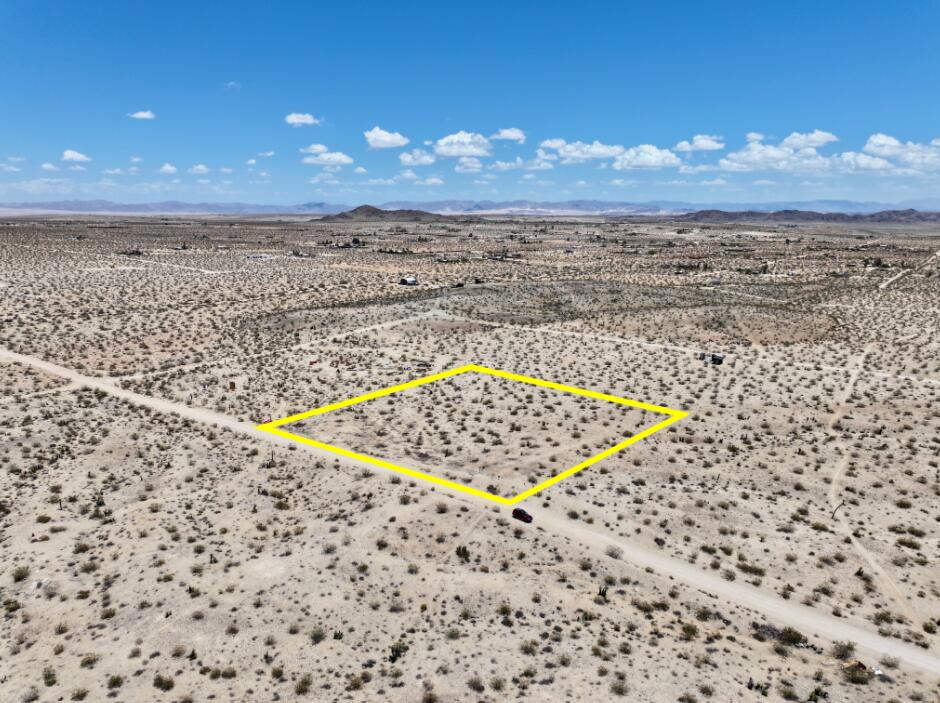 Owner May Carry Financing Available! Discover your desert dream on this beautiful 2.3 acre parcel located in the sought-after Hidden River neighborhood of Joshua Tree. Surrounded by natural beauty and high-end desert homes, this property offers panoramic views, star-filled skies, and peaceful seclusion. All just minutes from town and Joshua Tree National Park. Situated on a quiet road with direct access, this lot is ready for your vision. Power and water are nearby on Aberdeen (buyer to verify), making it ideal for a custom home, vacation rental, or designer compound. The gently sloping terrain is dotted with native flora including creosote, cholla, and desert yuccas, creating a pristine canvas for your high desert hideaway. Horse property. Only 17 minutes to the west entrance of Joshua Tree National Park which sees about 3 million visitors annually. 18 minutes to all amenities in Yucca Valley. 55 minutes to Palm Springs. This zip code is rapidly becoming one of Southern California's most in-demand destinations for artists, musicians, and investors. More celebrities are calling Joshua Tree home than ever before. Zoning may allow for a home and guest home. Buyers must contact the county planners with all questions on building and uses. Buyers must contact the appropriate utilities agencies with all questions on utilities. Lot size may vary slightly, buyer must investigate. APN: 0599-281-07-0000 GPS: 34.19548, -116.30648 Address is for marketing purposes only and is not an assigned address.