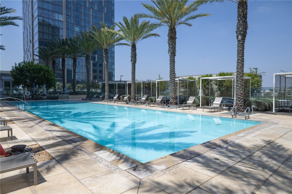 Experience elevated urban living in this stunning high-rise condo unit 1105 located in prestigious Metropolis Tower II at the vibrant heart of Downtown Los Angeles. This sleek and modern residence offers breathtaking panoramic views of the city skyline, floor-to-ceiling windows, and an abundance of natural light. The open-concept layout features premium finishes, hardwood flooring, a designer kitchen with upgraded quartz countertops ,high-end built-in stainless-steel appliances, and custom blinds. The window is facing pool and green belt area. The bedroom offers serene views and ample closet space, while the spa-inspired bathroom provides a luxurious retreat. Residents enjoy access to a full suite of resort-style amenities, including a 24-hour security and concierge service, business and conference centers, movie theater - perfect for hosting events and family and friends gatherings; as well as dog park, BBQ area, state-of-the-art fitness center and yoga studio, sky pool, spa and cabanas, kid's playground, private screening room, and secure parking. This luxurious condo is conveniently and perfectly situated within walking distance to LA Live, Crypto.com Arena, fine dining, cultural hotspots, and major business centers. This is downtown living at its finest — ideal for professionals, creatives, and anyone who appreciates the energy of city life.