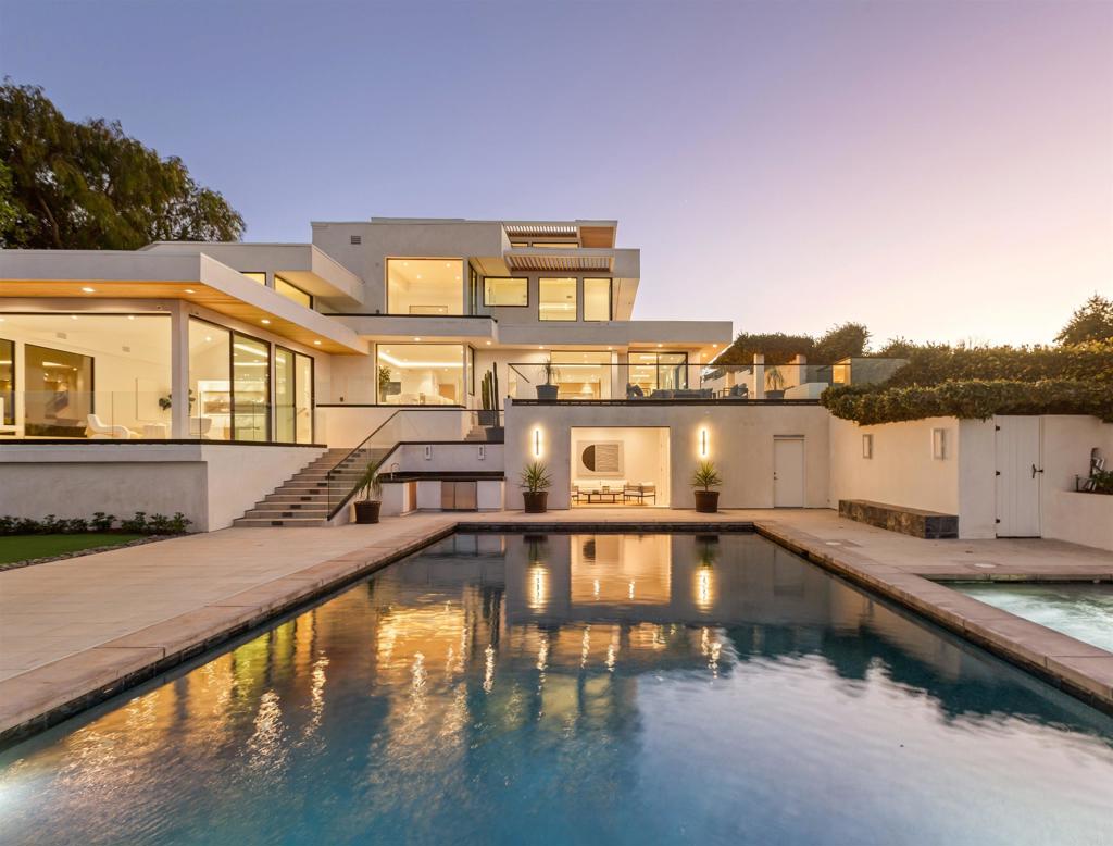 Nestled in the heart of La Jolla, 2082 Via Casa Alta stands as a masterpiece of contemporary design and luxury living. Recently reimagined through a complete rebuild, this breathtaking estate offers a seamless blend of modern elegance and timeless sophistication. Boasting a magnificent primary suite and four additional spacious bedrooms, along with an oversized bonus room, the home is perfectly suited for both relaxation and entertaining. Every room is thoughtfully designed to capture the stunning, unobstructed views of the Pacific Ocean and surrounding mountains. And some rooms also boast the equally stunning southern views over the bay out to the Coronado islands. The gourmet kitchen will excite any chef with it’s beautiful design open to the magnificent family room, dining room and living room. Step outside to your private oasis featuring a sleek, oversized rectangular pool, a stylish pool house, and a sprawling pool deck ideal for soaking in the sun or hosting gatherings. As evening falls, gather around the fire pit to enjoy the coastal breeze and unparalleled sunset vistas. This property is a rare opportunity to experience luxury coastal living at its finest. 2082 Via Casa Alta is more than a home— it’s a dream lifestyle.