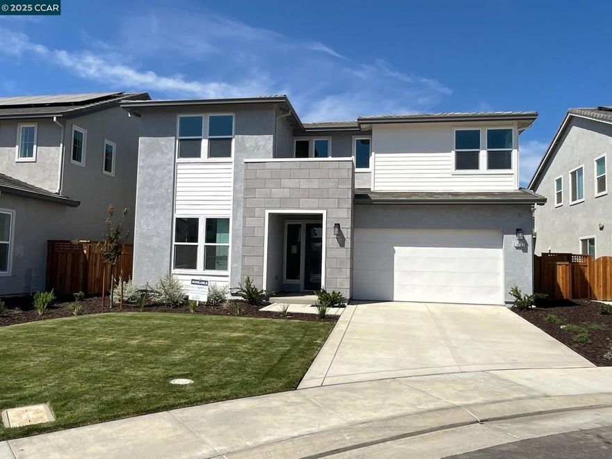Luxurious, spacious Residence 4 with full in-law quarters available for June/July move-in, just in time for the kids to register for the exceptional River Islands schools! This luxury 5 bedroom home features a full in-law quarters with separate entrance, sitting room with full kitchenette, and bedroom. In the main home area, a chef's island kitchen showcases an abundance of cabinets and large walk-in pantry with glass door. The spacious fitness room/office space with a glass wall to the greatroom is a unique and welcome addition.  Also, there is a 16' center pull 4 panel slider that connects the great room to the outdoor California Room offering an abundance of natural light and entertainment space. The Primary bedroom suite features a luxurious bath complete with a gorgeous freestanding tub, spacious shower, separate dual vanities, and a large walk-in closet. Families will enjoy the upper loft while the upstairs laundry is convenient to the secondary bedrooms, Jack and Jill bath and more. SOLAR, EV Charger and Tesla BATTERY BACK UP is INCLUDED. PRICE REDUCED for Fall Promotion- Now save over $100,000 for quick move-in!