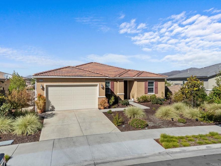 Welcome to your dream home in the heart of Winchester, CA! This beautifully maintained 3-bedroom, 2-bathroom residence offers 2,091 square feet of comfortable living space, thoughtfully designed with an open floor plan that’s perfect for modern living and effortless entertaining. The heart of the home is a gorgeous, upgraded kitchen featuring sleek finishes and ample counter space, opening seamlessly to the dining and living areas. Step outside to your own private entertainer’s paradise—an inviting patio complete with a cozy fire pit, ideal for enjoying cool evenings under the stars. Also boasting mature fruit trees including apple, orange, tangerine, and lemon, along with two water fountains that enhance the peaceful atmosphere. What truly sets this home apart are the breathtaking, unobstructed panoramic mountain views from every rear window—no neighbors behind, just serene natural beauty. The community is quiet, friendly, and meticulously kept, with low HOA fees and the added bonus of leased solar for energy efficiency. Even the garage is a standout, featuring a durable epoxy floor for a clean, polished look. Located in a highly desirable area with close proximity to shopping and dining, this home offers a rare blend of peaceful retreat and convenience. Don’t miss the opportunity to own this incredible property—homes with views like this don’t come along often!