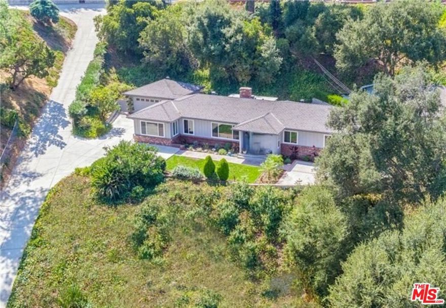 A rare LEASE opportunity to live in the exclusive Brookmere enclave in southwest Pasadena. The Brookmere enclave is a small, gated community located in the San Rafael Hills area of southwest Pasadena. This private neighborhood comprises only 19 residences, spread across 21 acres, overlooking the tranquil, private Johnson Lake. Originally a natural spring-fed pond, Johnson Lake was expanded in 1876 by Prudent Beaudry, a former mayor of Los Angeles. Pass through the private gates into the prestigious San Rafael Hills and discover this welcoming single-story, mid-century home perched on the hillside steps from the historic three-acre lake. Enjoy picnics beneath the sycamores in the grassy meadow, take a peaceful row on the lake, or relax by the inviting oversized pool in a serene, woodsy setting that feels like a private country club. One of only 19 homes in this historic gated enclave, this traditional hillside residence sits on an expansive 18,000-square-foot lot and features three bedrooms and two baths, including a spacious primary suite with a dressing area and full bath. Classic built-in closets, an additional office or study, and a generous living room with a brick fireplace and large picture windows frame north-facing views of Mount Wilson and the San Gabriel Mountains. The galley kitchen includes a breakfast bar and a pass-through to the formal dining area, while the light-filled family room offers picturesque views of the lake and mountains, ideal space for a breakfast room, artist's studio, or retreat. Beautiful hardwood floors and timeless 1950s details throughout complete this exceptional lease opportunity in one of Pasadena's most sought-after private communities.