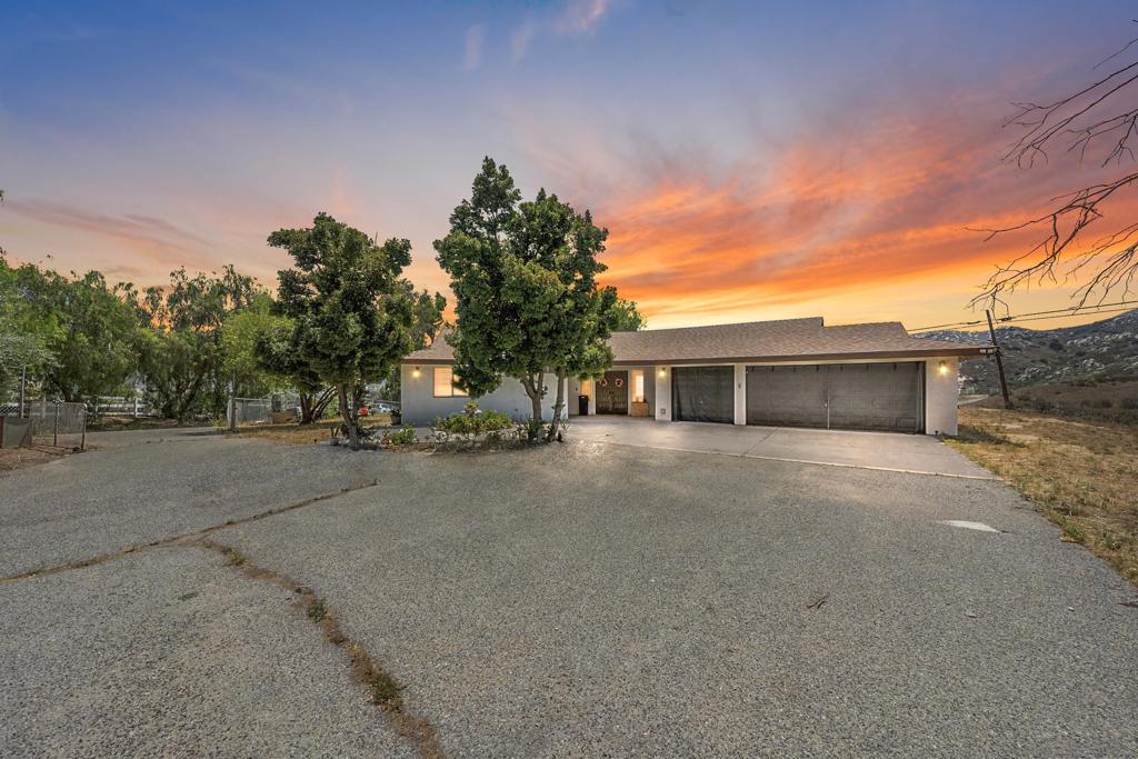 . Renovated View Home on Over 2 Acres. Fully renovated single-story home with 3-car finished garage, sitting on 2+ acres of fenced land with hillside views from nearly every room. Interior features include an open-concept floor plan, quartz fireplace surround with 75” recessed TV niche, level-5 smooth wall finish, and wood-look ceramic tile flooring throughout. Kitchen offers dark oak cabinetry, quartz countertops, dual bar seating peninsulas, decorative tile backsplash, and high-end appliances. Bathrooms feature vessel sinks, frameless glass showers, rain-head fixtures, waterfall faucets, and a freestanding soaking tub with WoodBridge faucet. Exterior highlights: covered patio, graded second pad, well water, septic, and solar power. Located off a private road with full fencing. Private, and move-in ready.